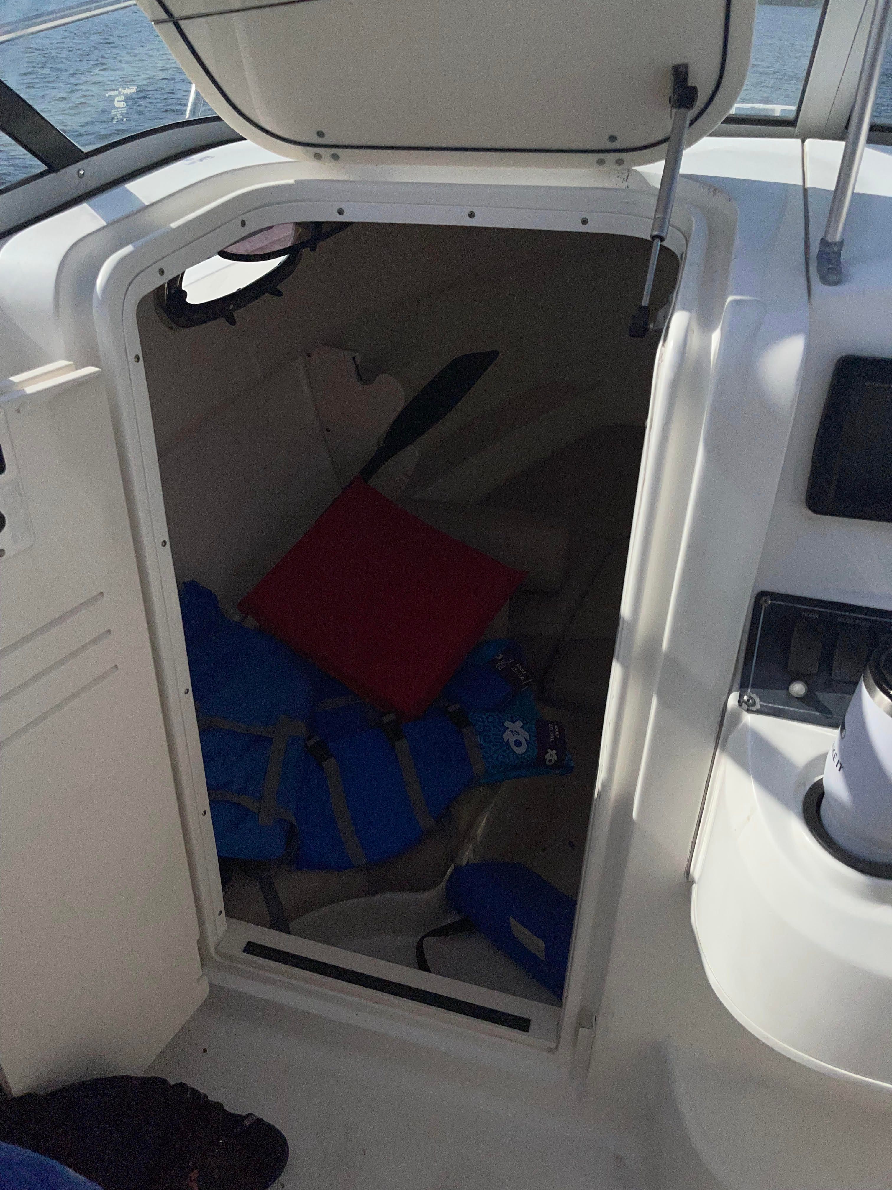 Interior of 2010 Boston Whaler 235 Conquest with cushion and life jacket.