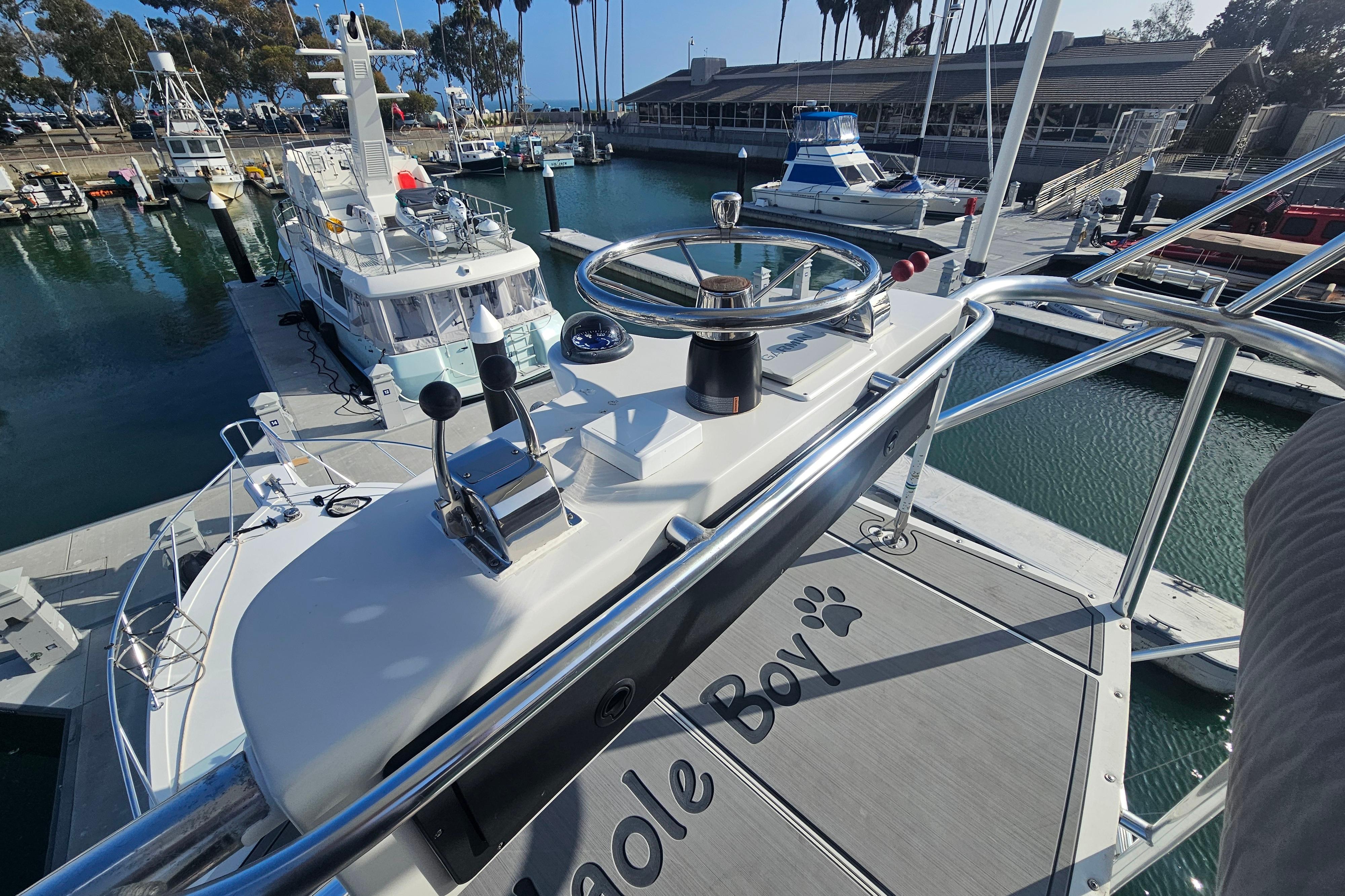 2003 Topaz 32 Express boat docked at marina, view from helm station.