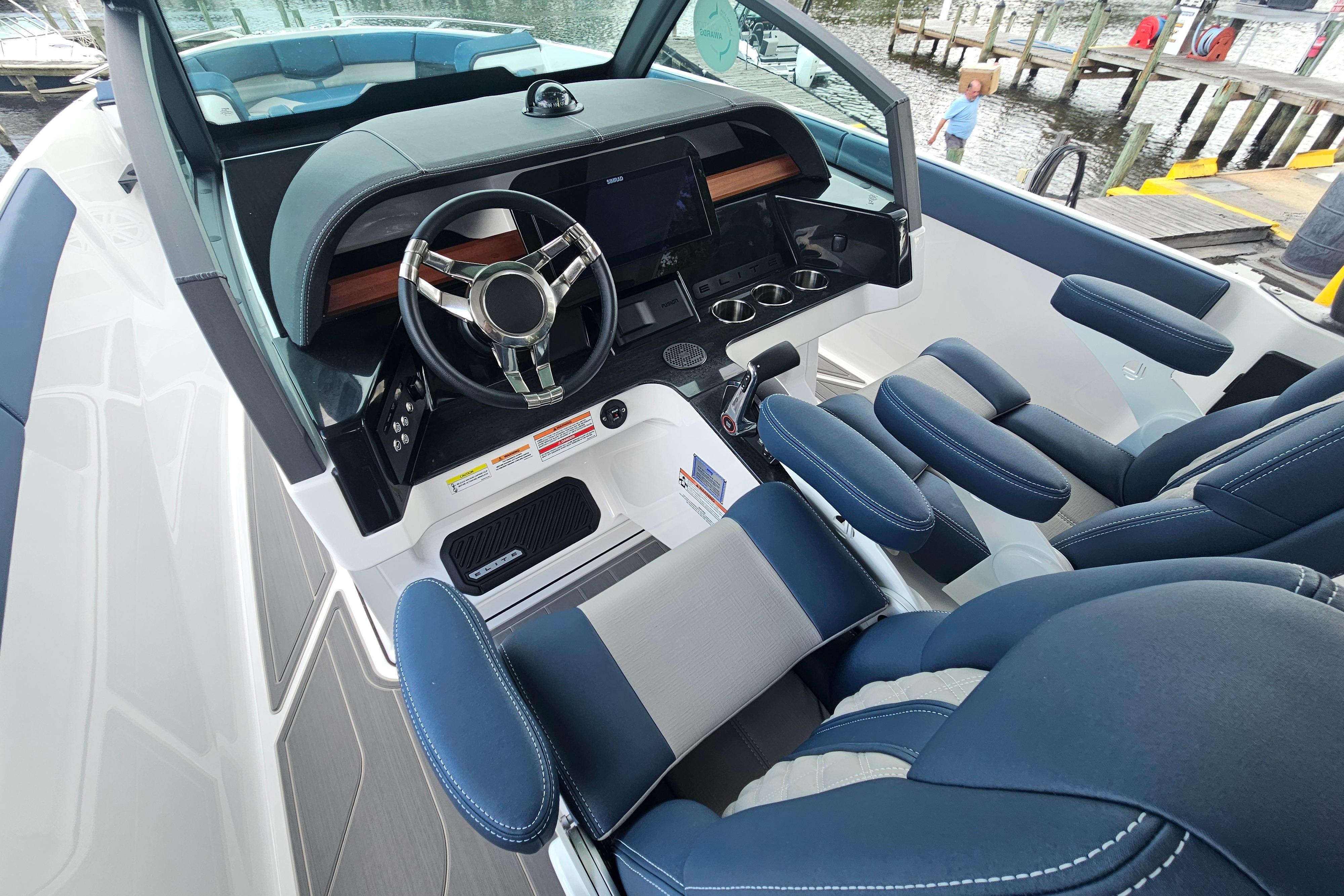 2026 Monterey Elite 27 OB boat interior with modern steering and plush seating.