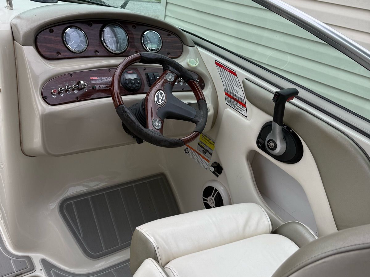 The image shows the cockpit of a 2007 Sea Ray 240 Sundeck with a sleek steering wheel and instruments.