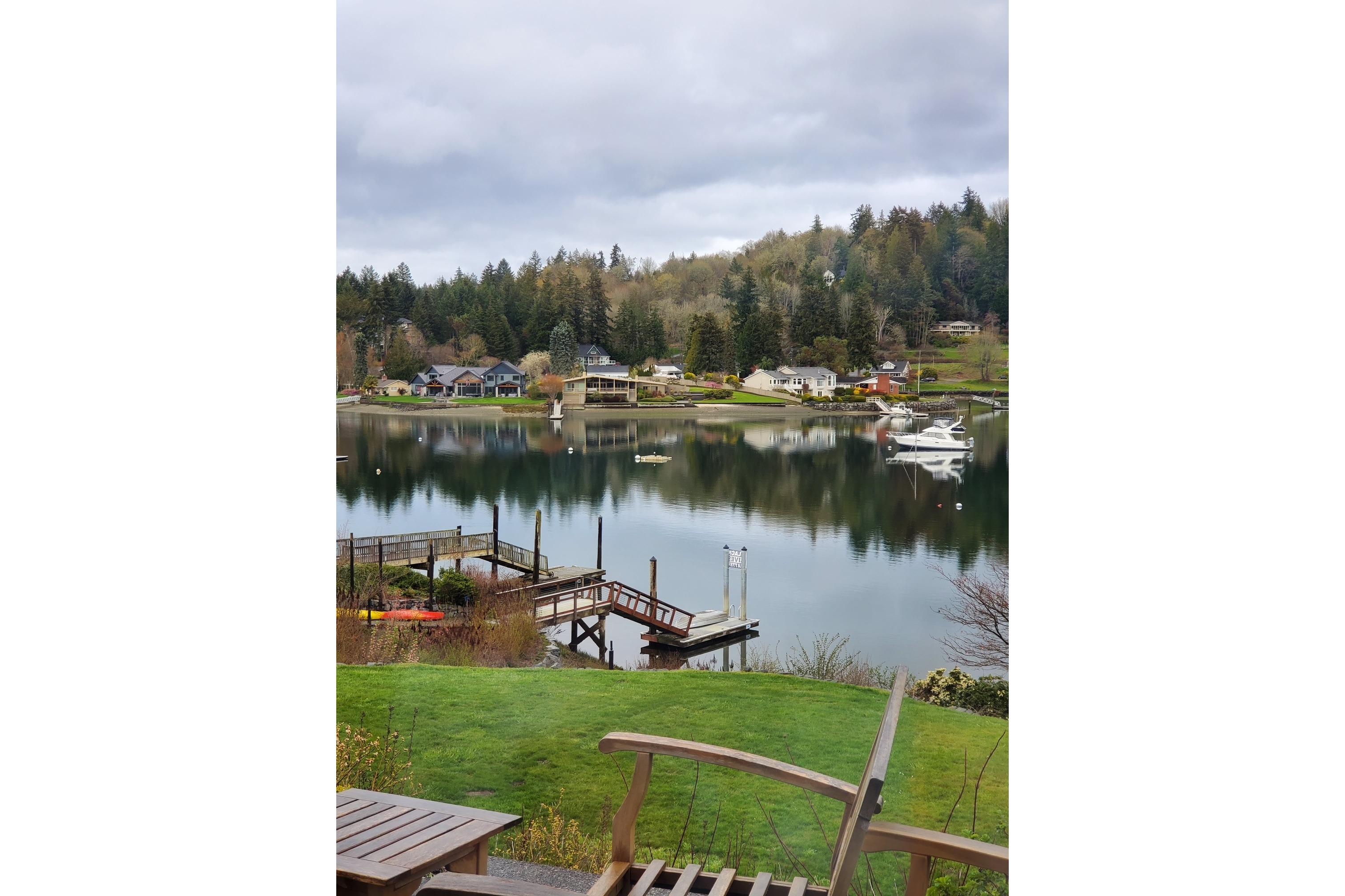 Scenic lakeside view with a 1998 Bayliner 3388 Command Bridge Motoryacht docked.