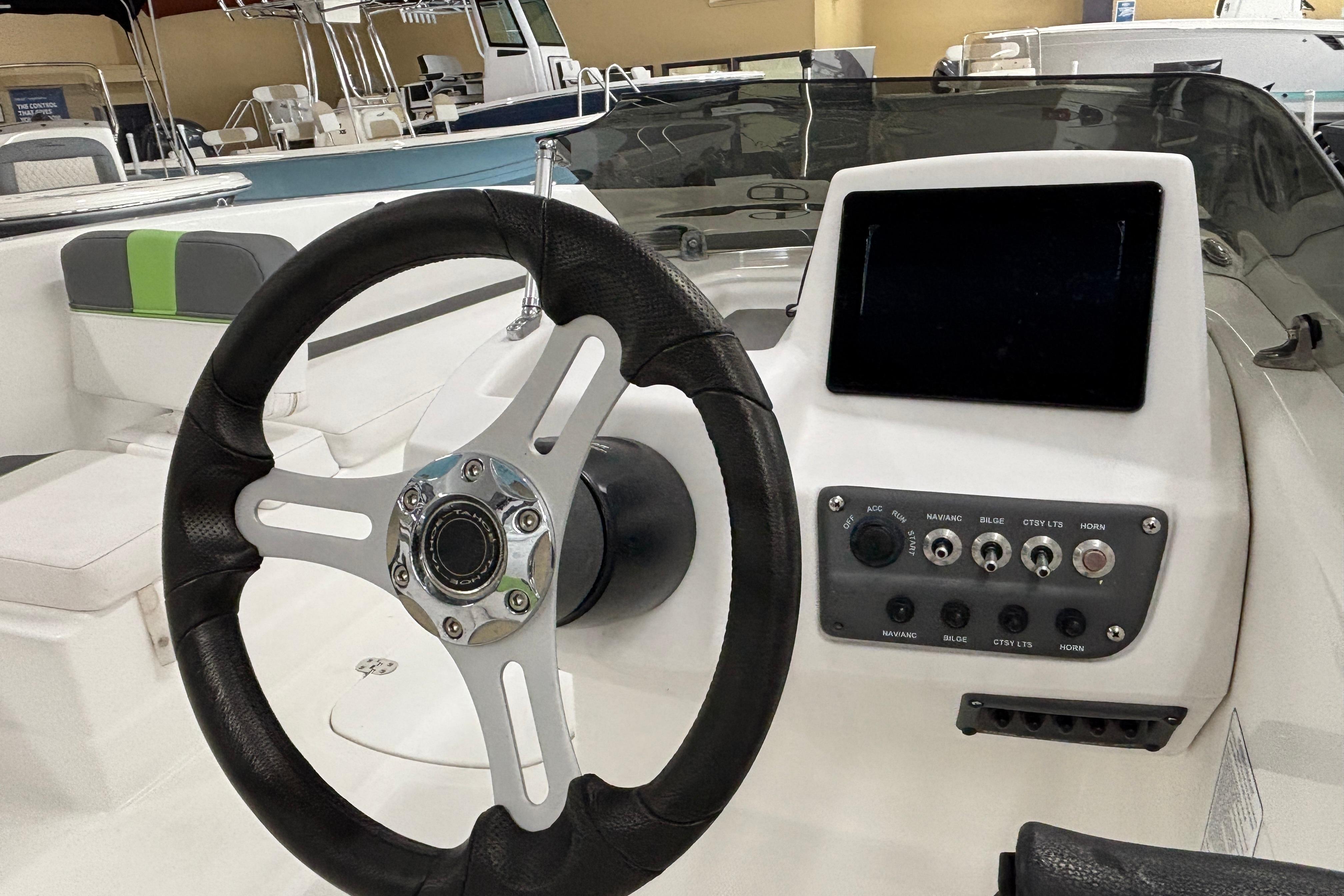 2024 Tahoe T18 boat dashboard with steering wheel and control panel.