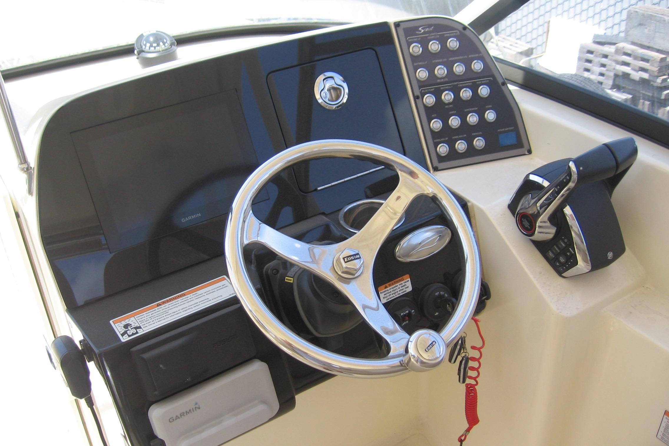 2024 Scout 255 Dorado boat dashboard with steering wheel and control panel.