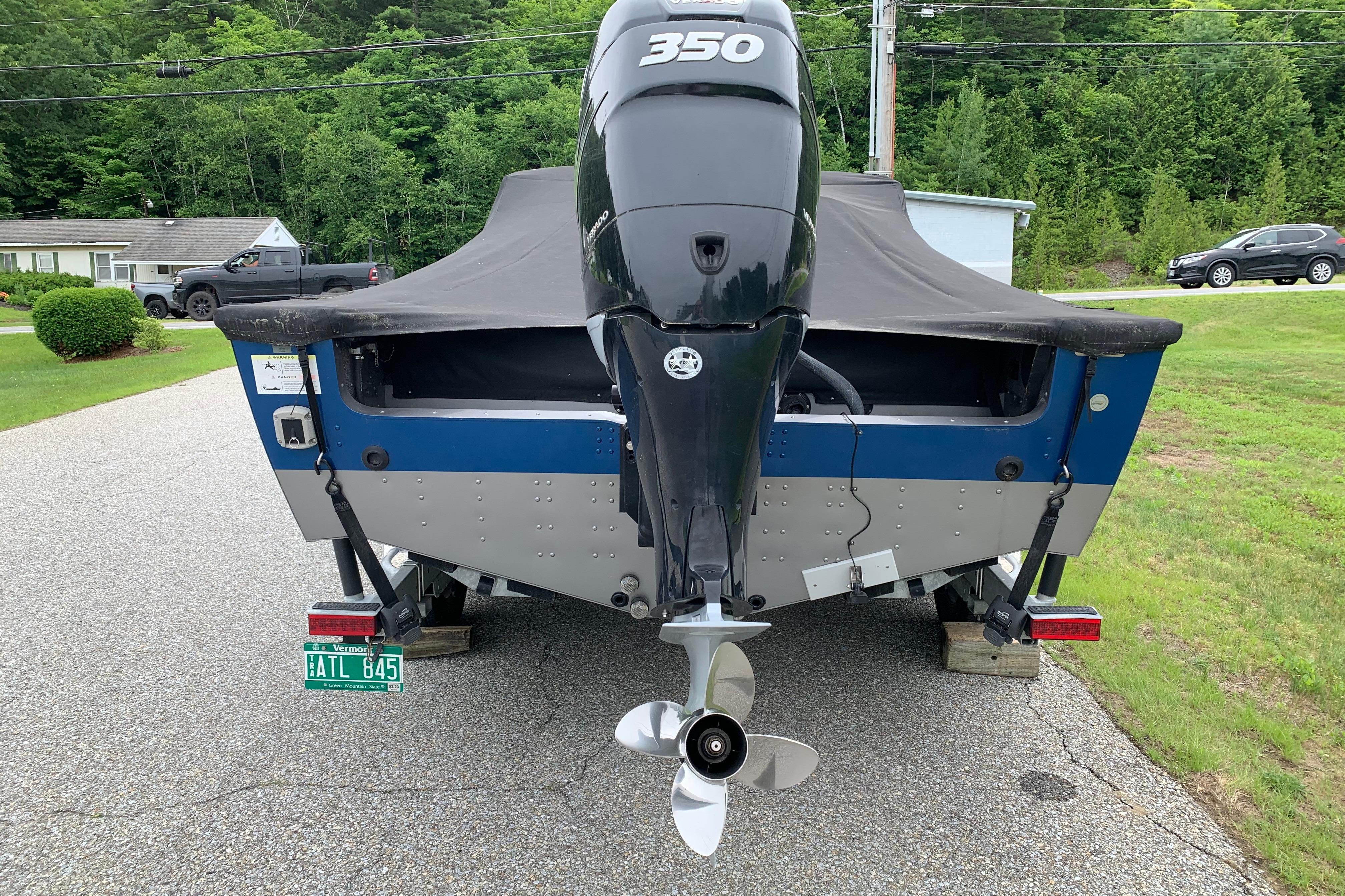 2019 Lund 2175 Pro-V boat with powerful 350 engine, parked on a driveway.