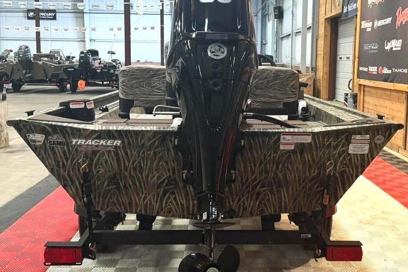 2026 Tracker Grizzly 1754 SC All-Welded boat with camo design in showroom.