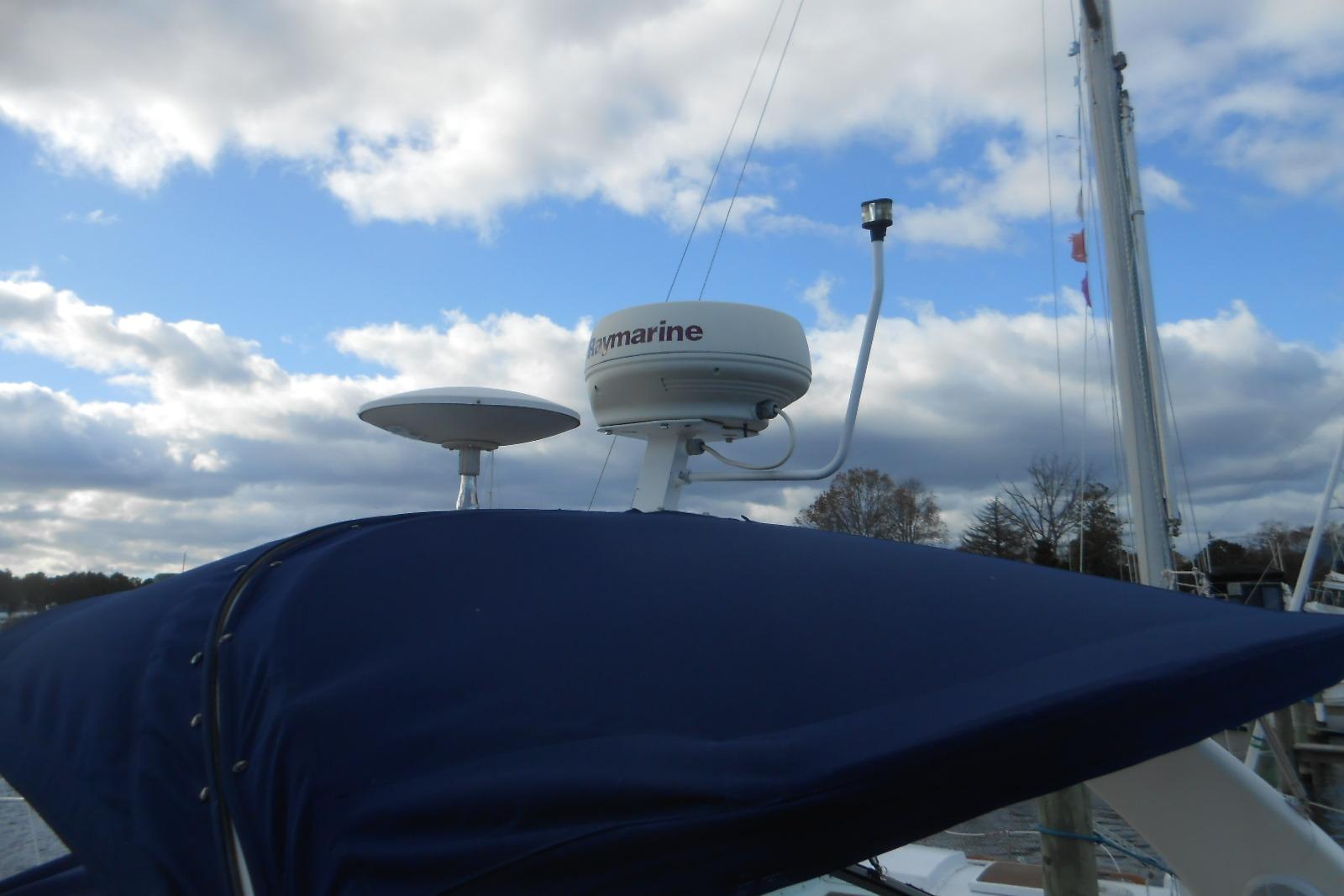 Radar equipment on a 2005 Sea Ray 340 Sundancer against a cloudy sky.