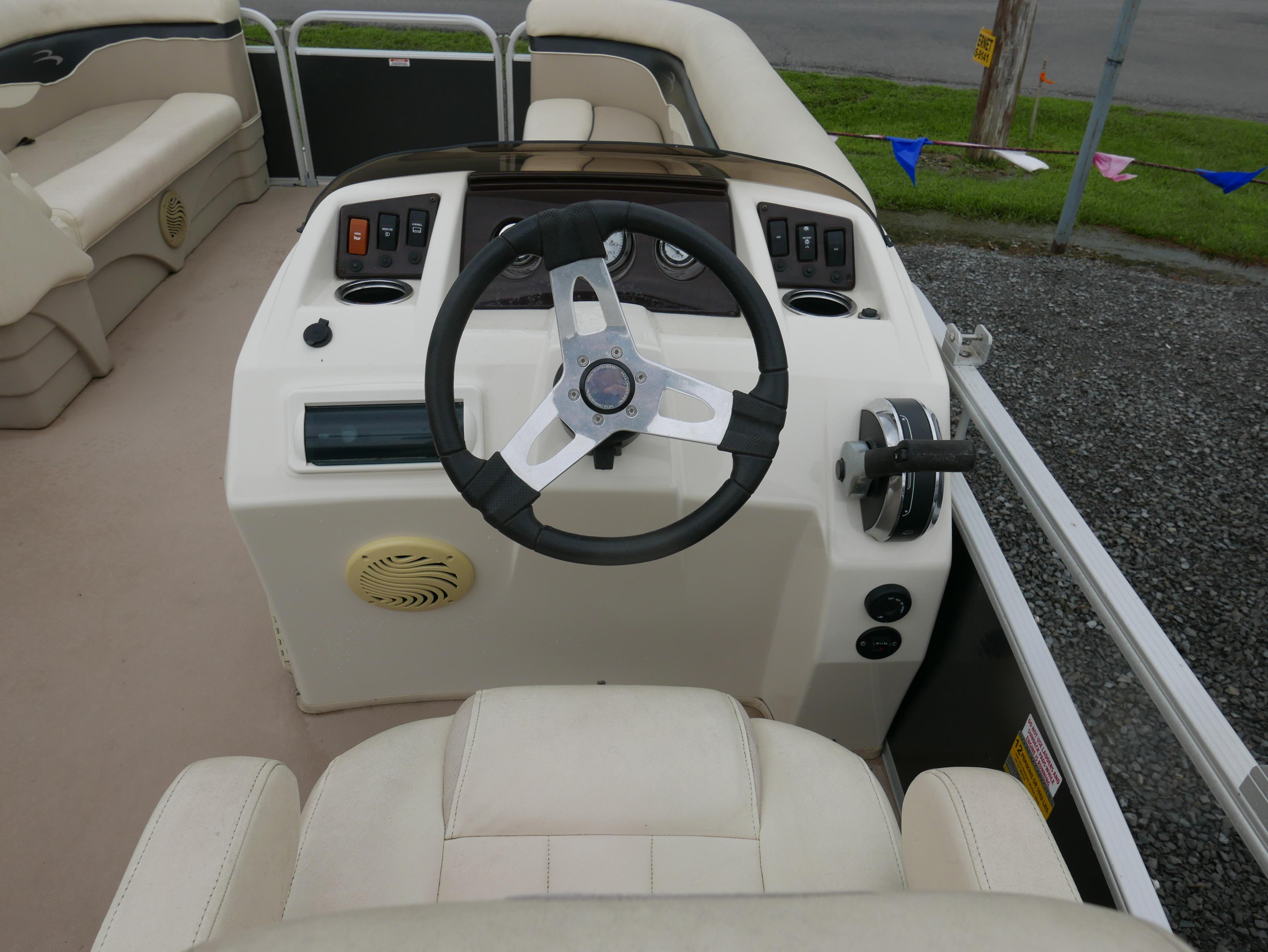 2013 Bennington 22SLX boat helm with steering wheel and control panel.