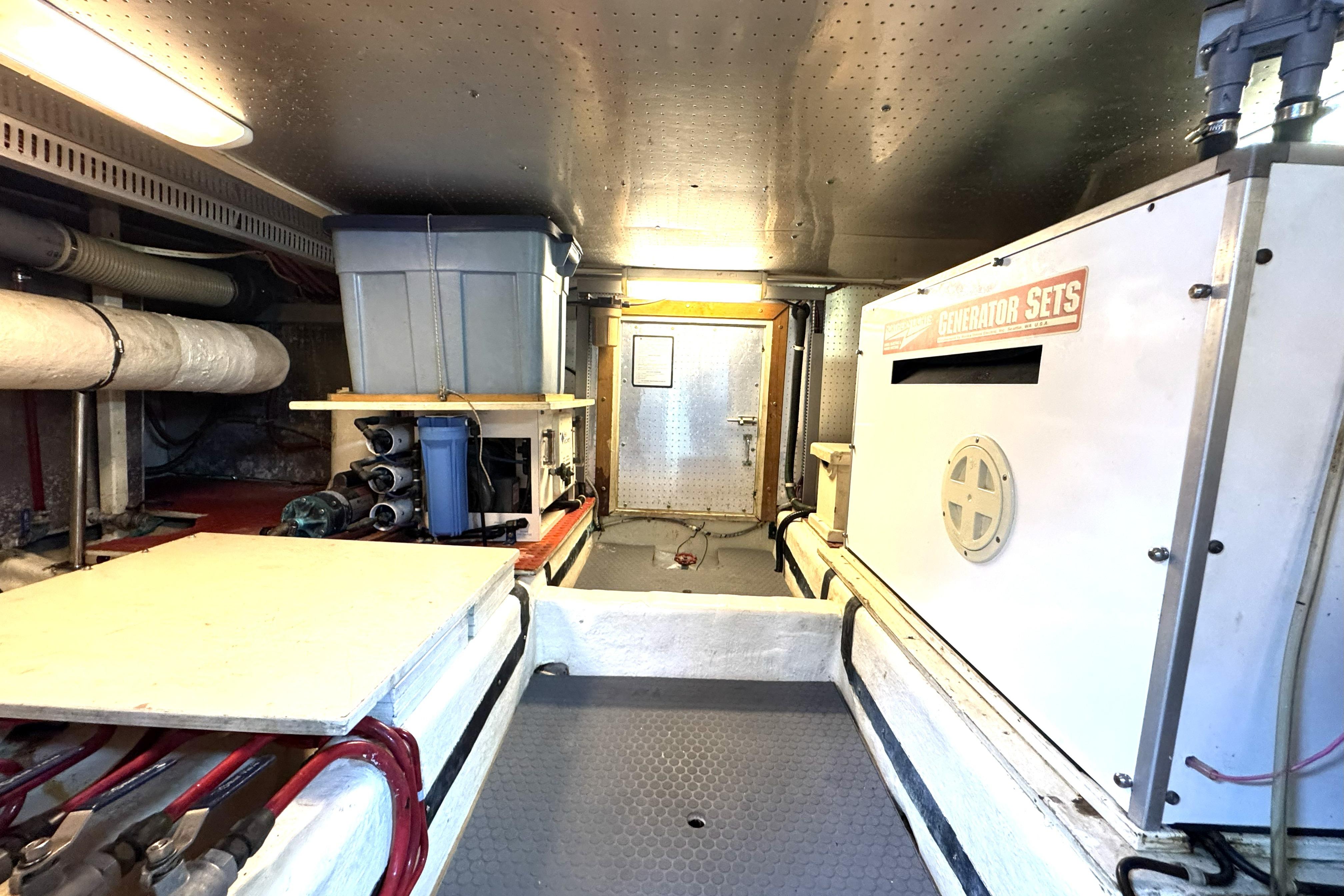 Engine room of 1988 Offshore Yachts 48 Sedan with generator and storage.