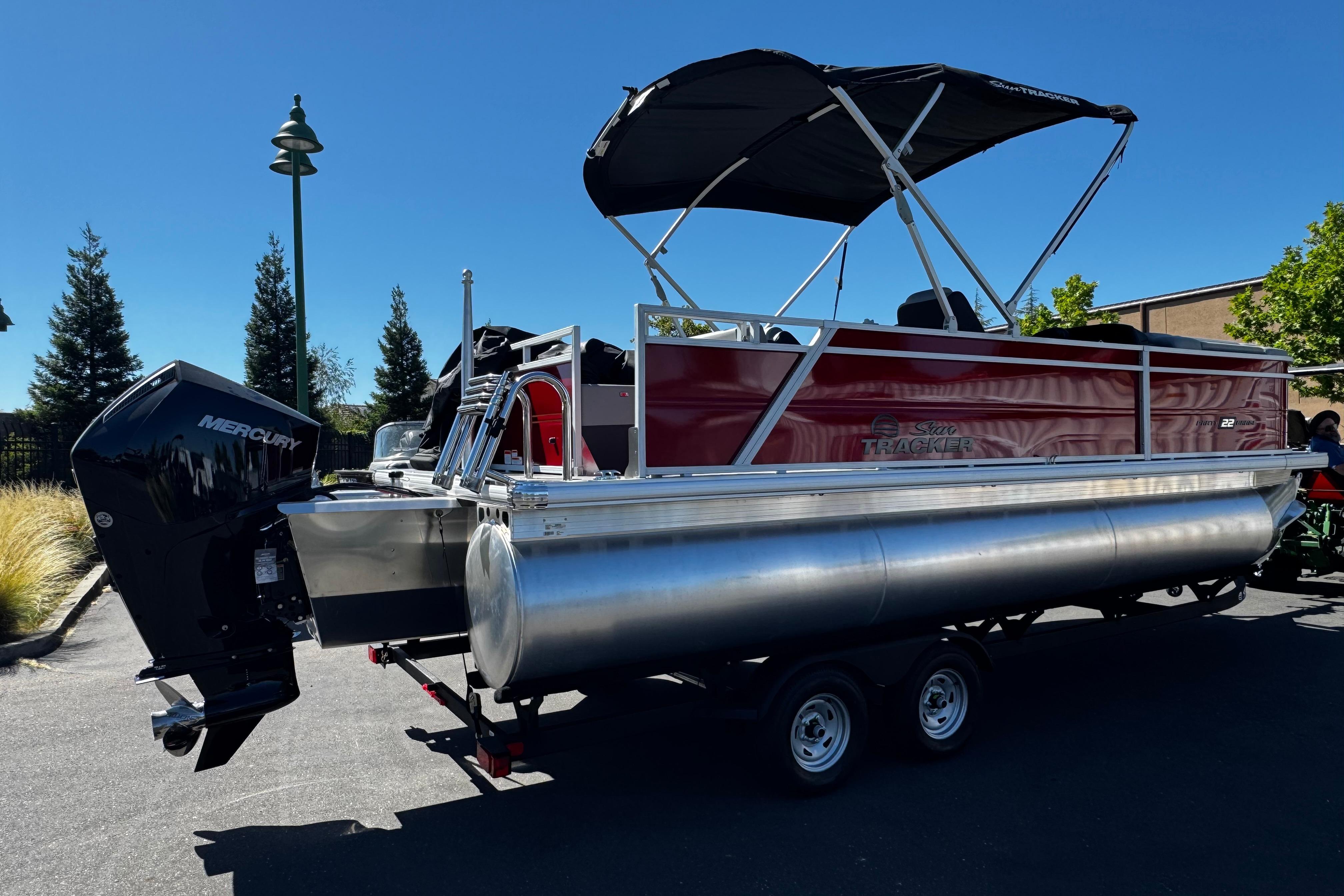 2026 Sun Tracker Party Barge 22 XP3 pontoon boat with Mercury engine on trailer.