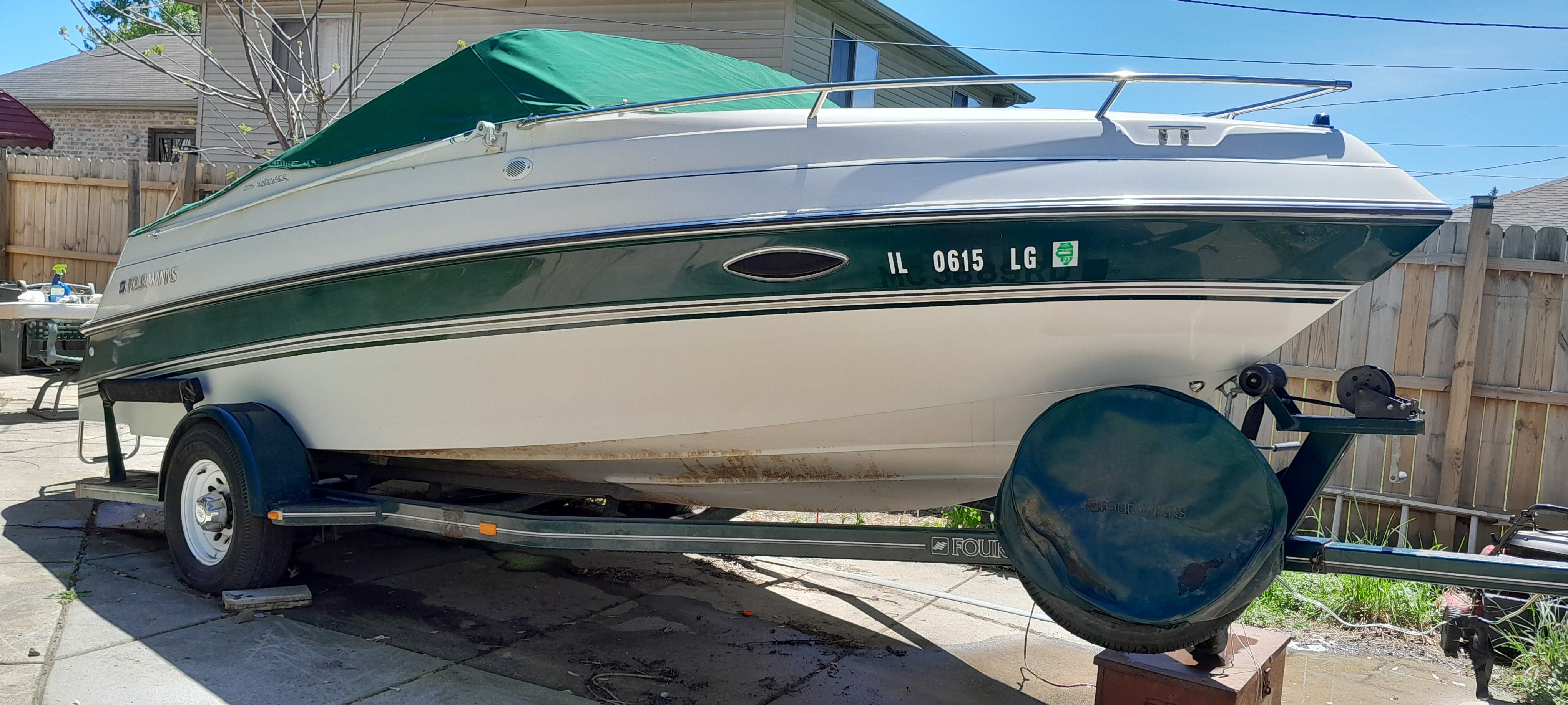 1995 Four Winns 205 Sundowner boat on trailer in yard.