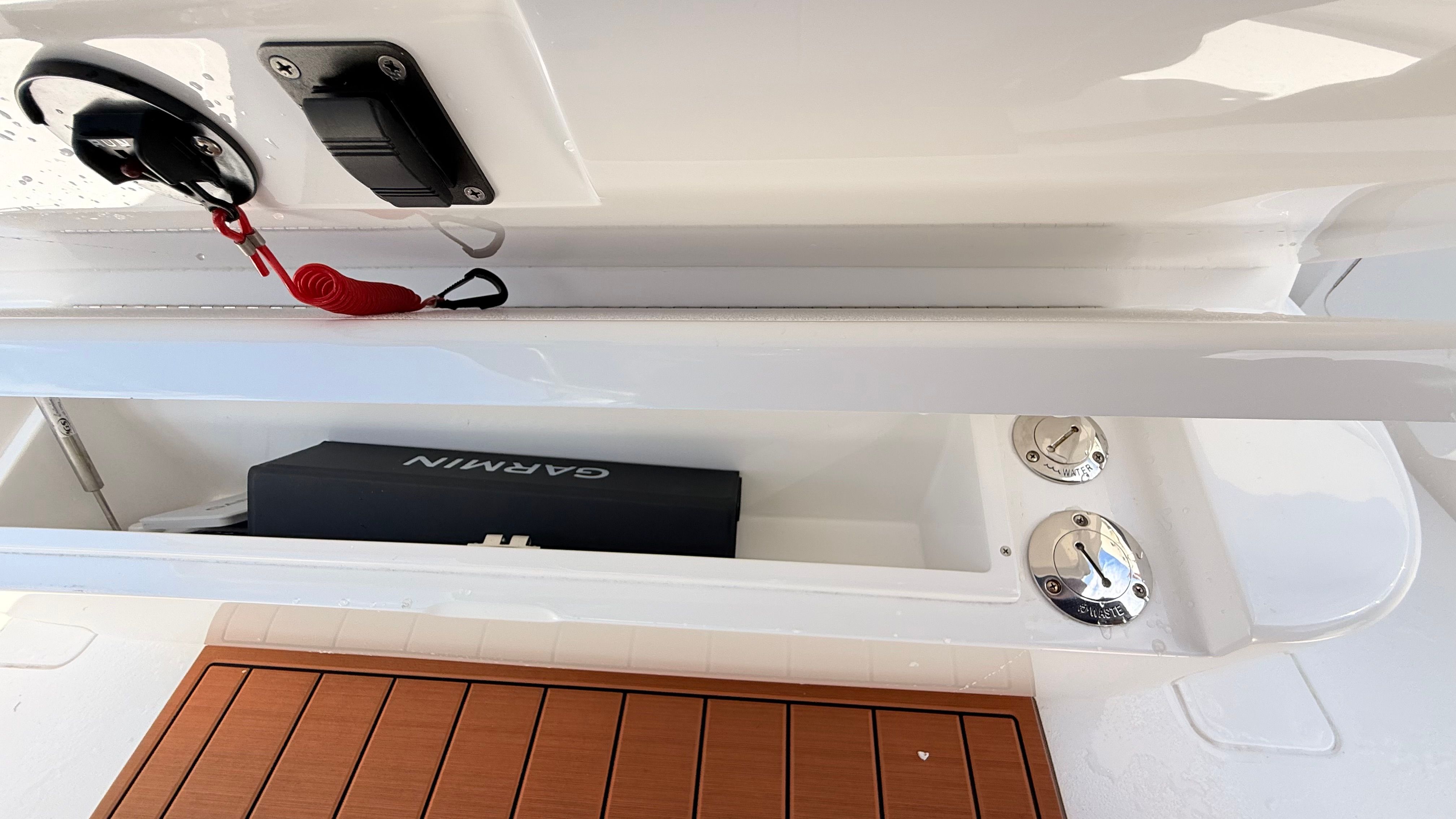 Valhalla Boatworks V33 2026, storage compartment with Garmin equipment.