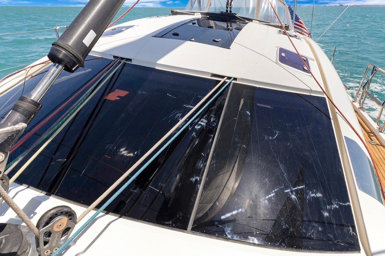2011 Southerly 57 RS yacht deck with ropes and windows, sailing on turquoise water.