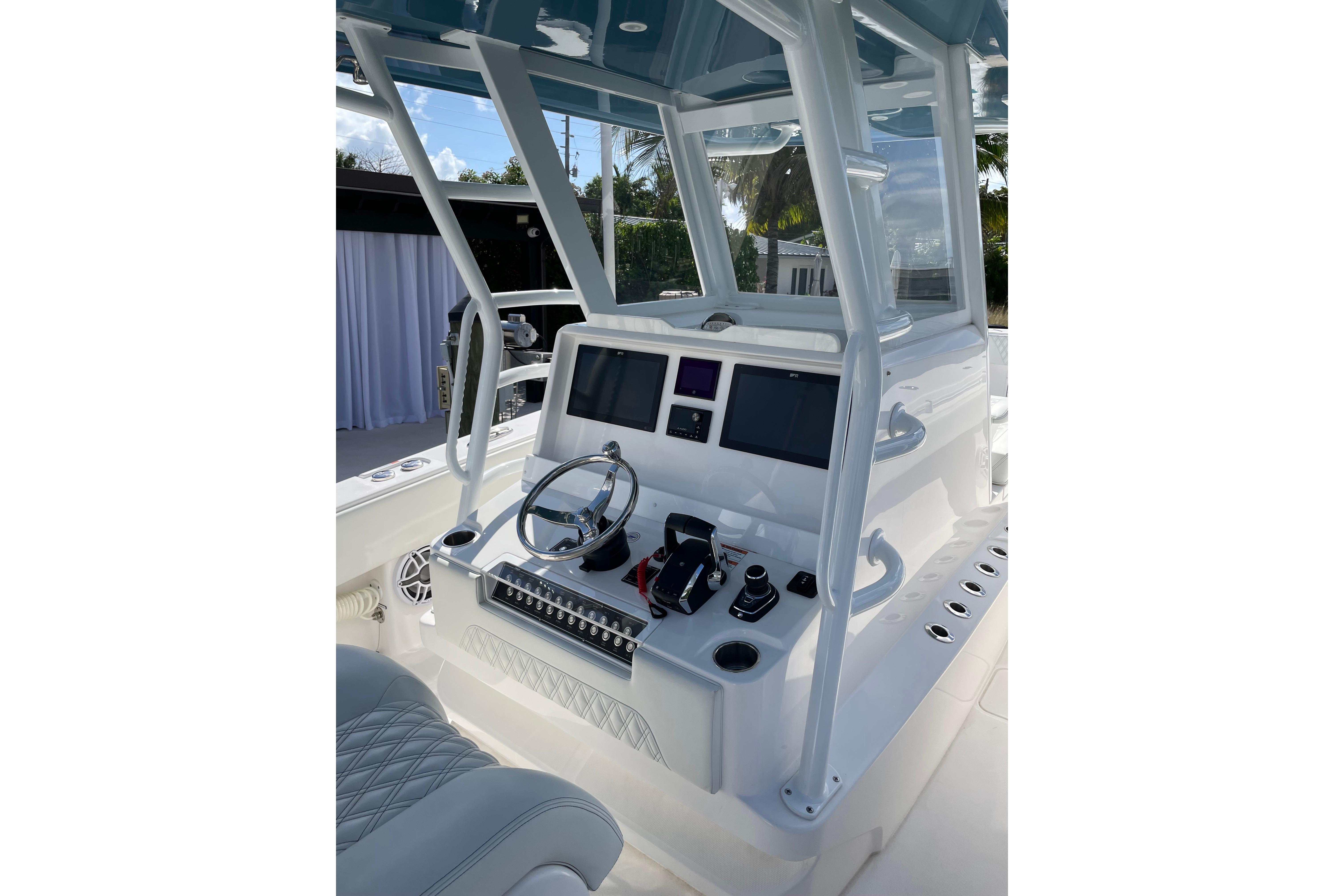 2024 Invincible 36 Open Fisherman boat cockpit with modern controls and steering wheel.