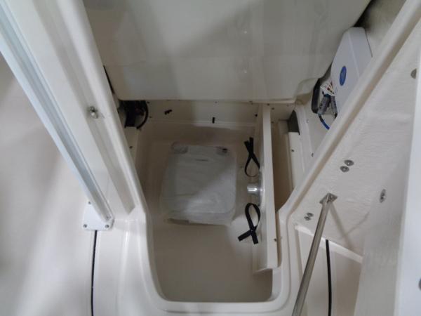 Interior of 2023 Robalo 246 Cayman with storage compartment.