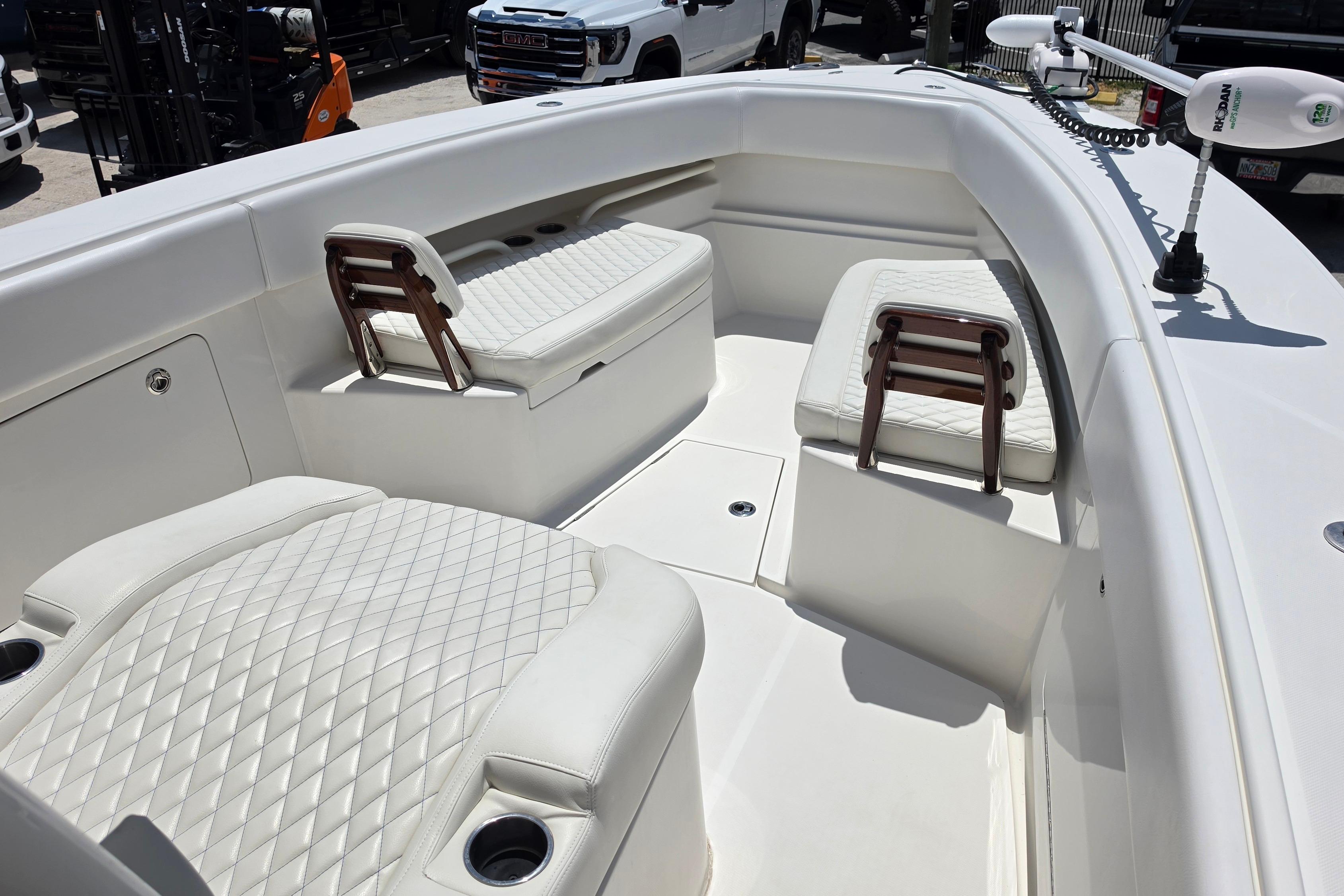 2020 Jupiter 34 HFS boat interior with white quilted seating and cup holders.