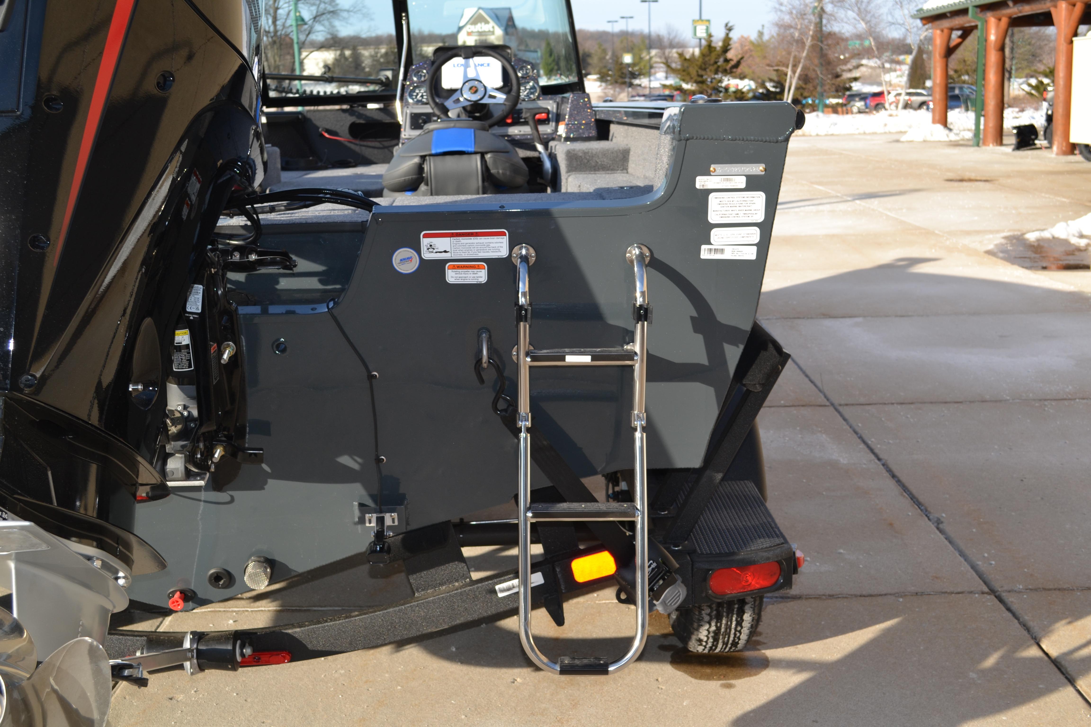 2026 Ranger VS1882SC Reata boat with ladder and motor, parked outdoors.