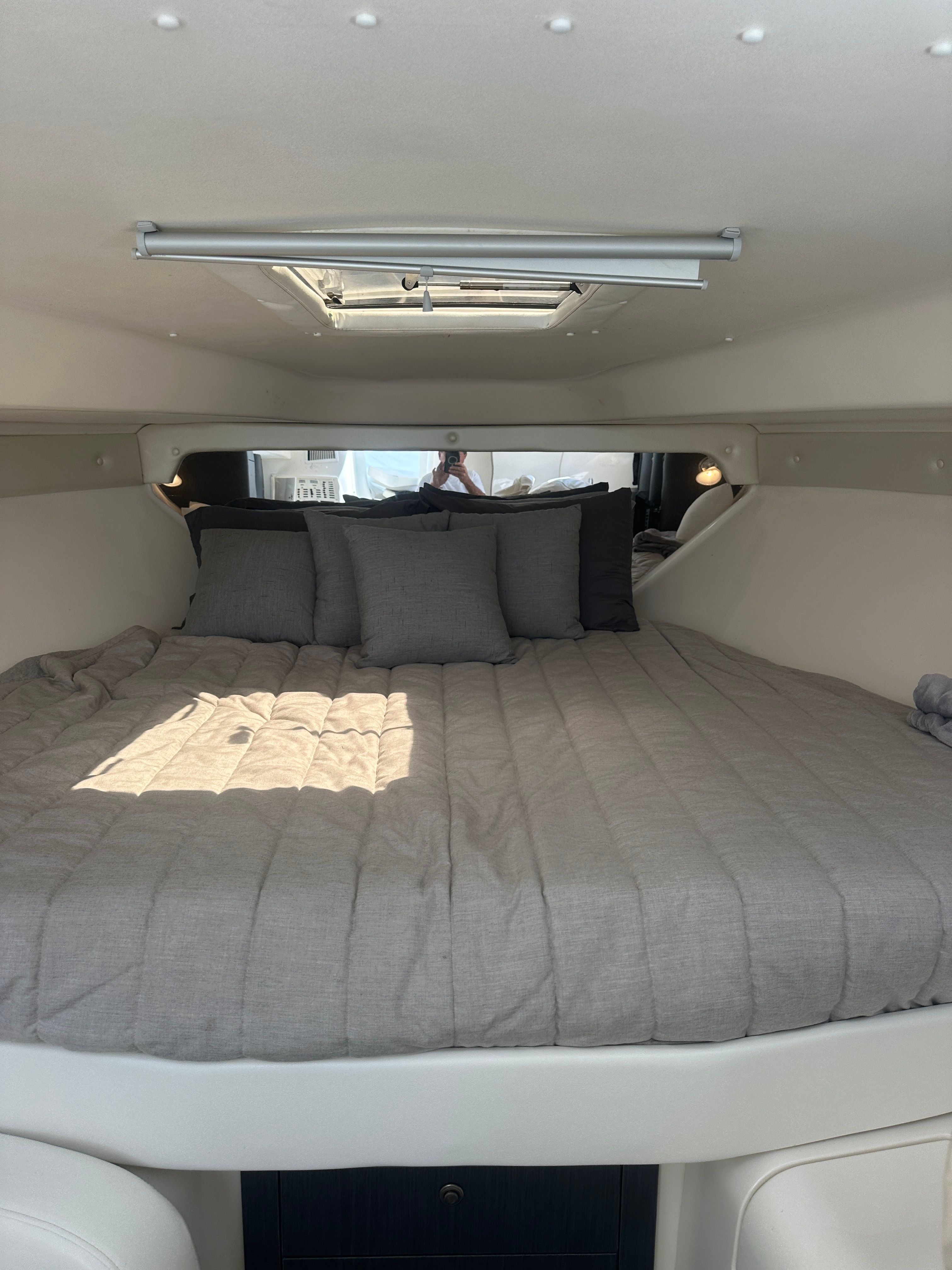 Interior of a 2004 Intrepid 377 Walkaround yacht, featuring a cozy bed.