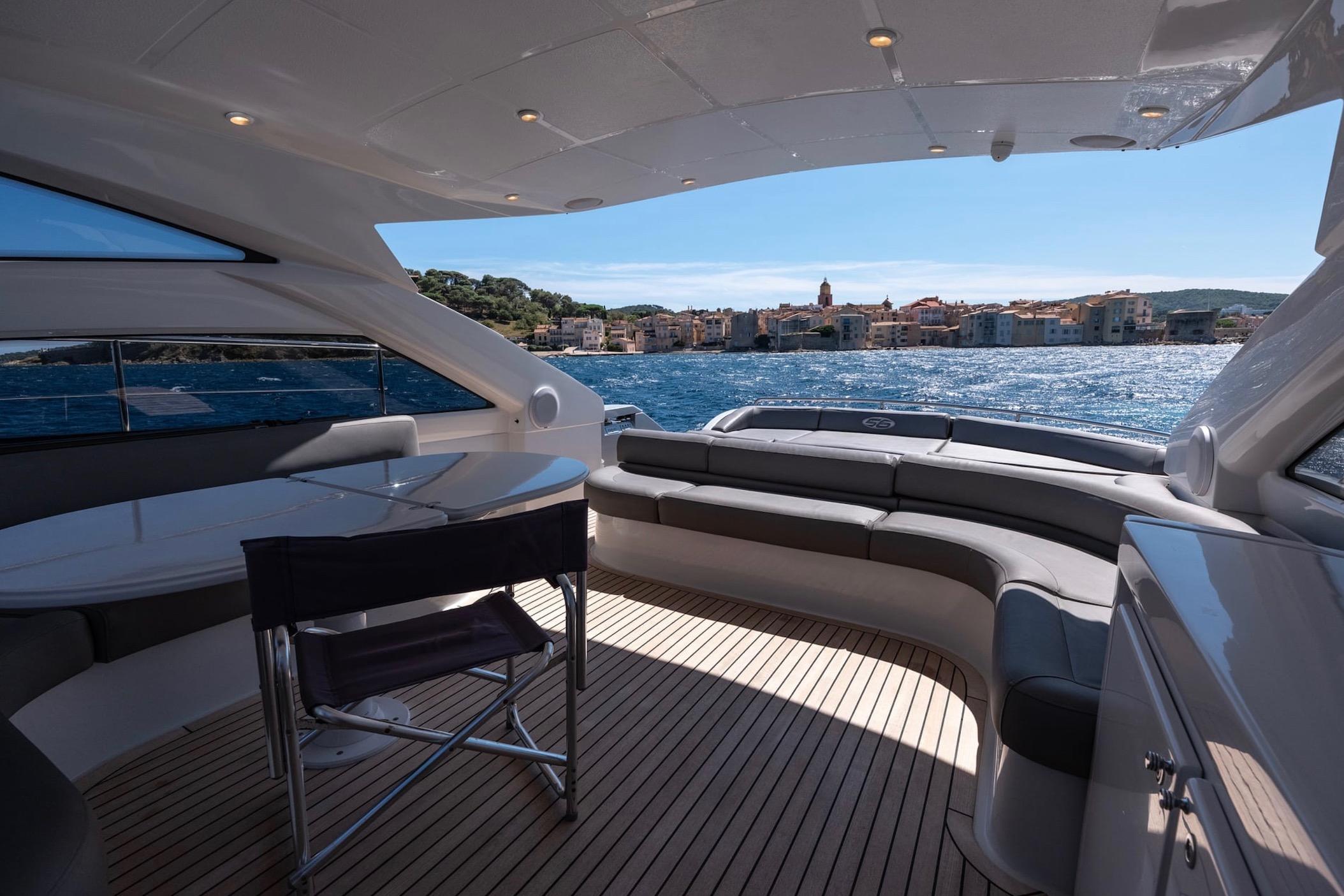 Luxurious 2006 Pershing 56 yacht interior with scenic ocean view.