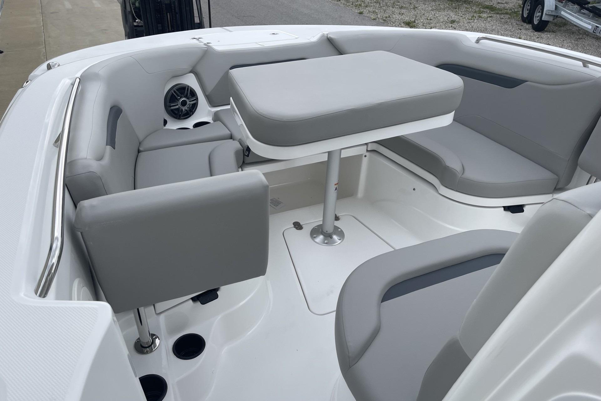 2026 Hurricane Center Console 24 OB boat interior with gray seating and table.