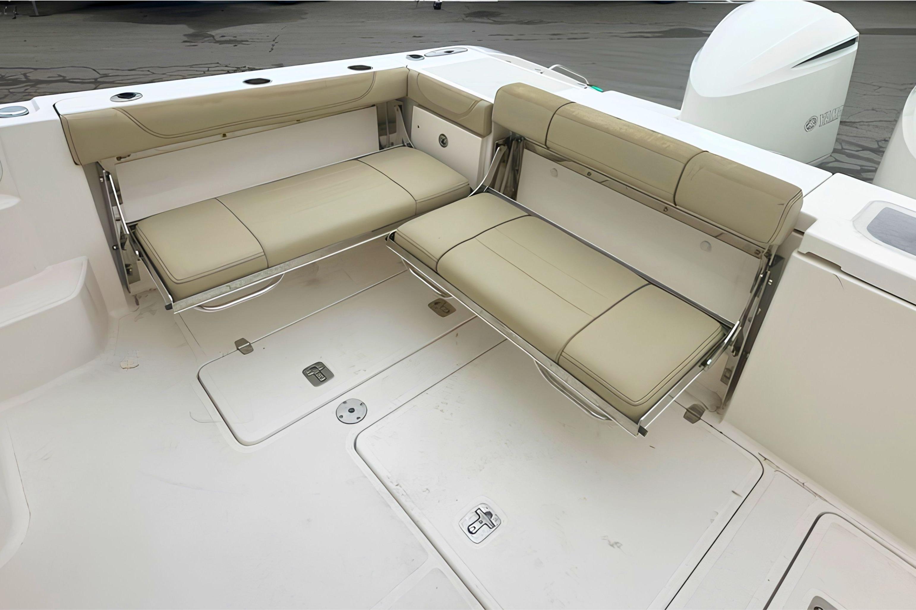 2017 Pursuit OS 355 Offshore boat with foldable beige seating in the cockpit area.