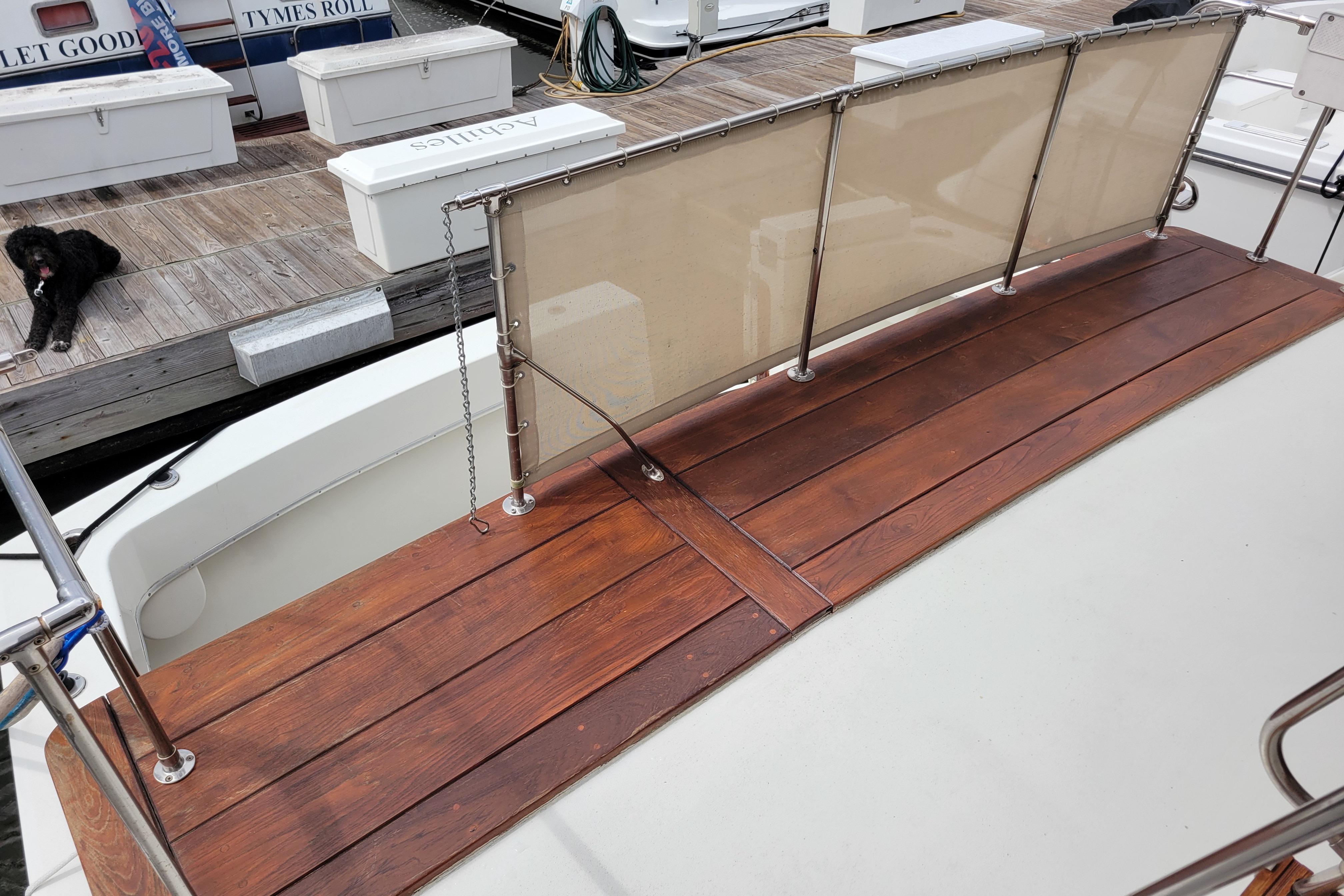 1980 Hatteras 53 Yacht Fisherman with wooden deck and docked at marina.