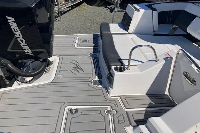 2024 Monterey M-65 boat deck with Mercury engine, featuring sleek seating and modern design.