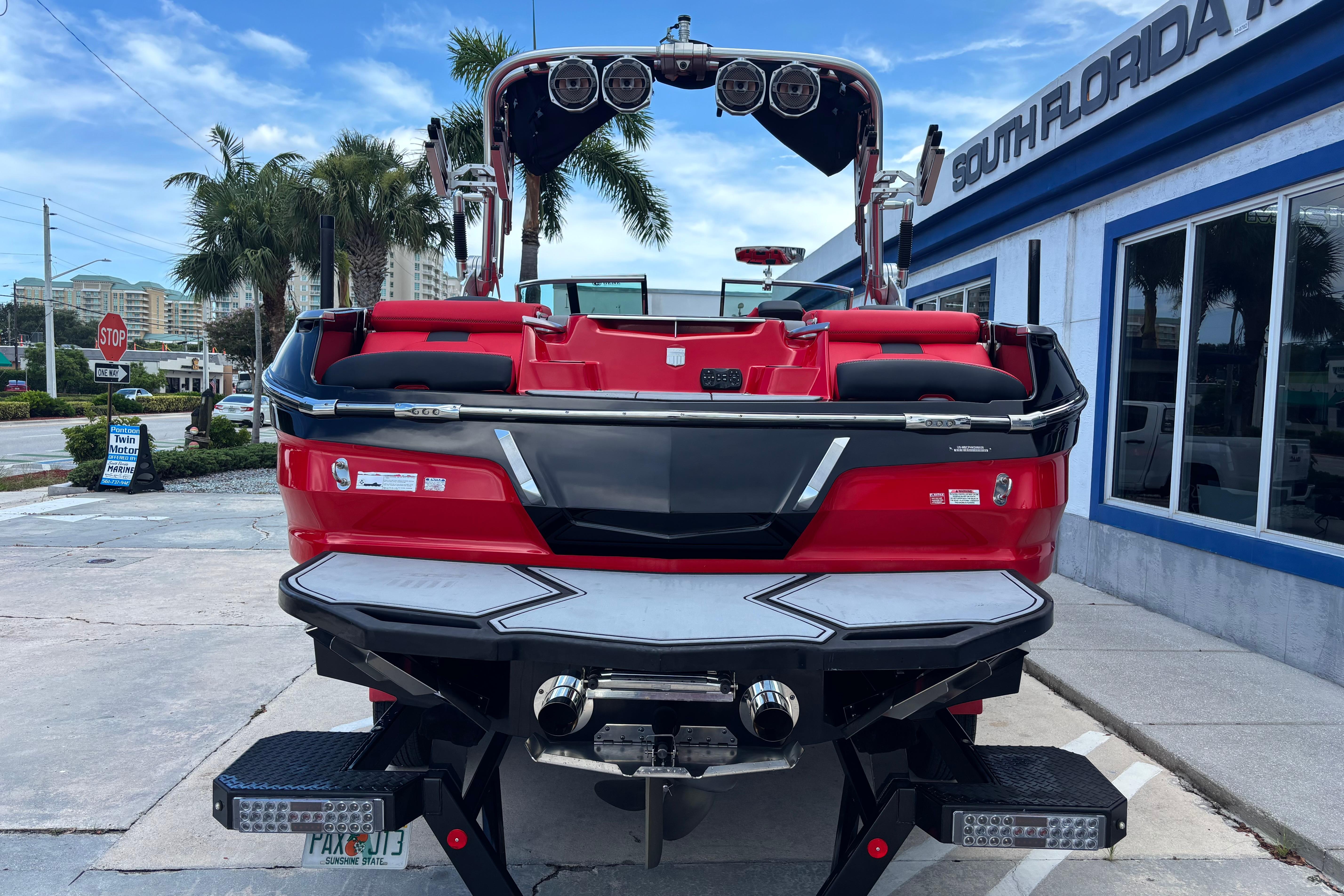 2020 MasterCraft X24 boat in vibrant red, parked outside South Florida dealership.