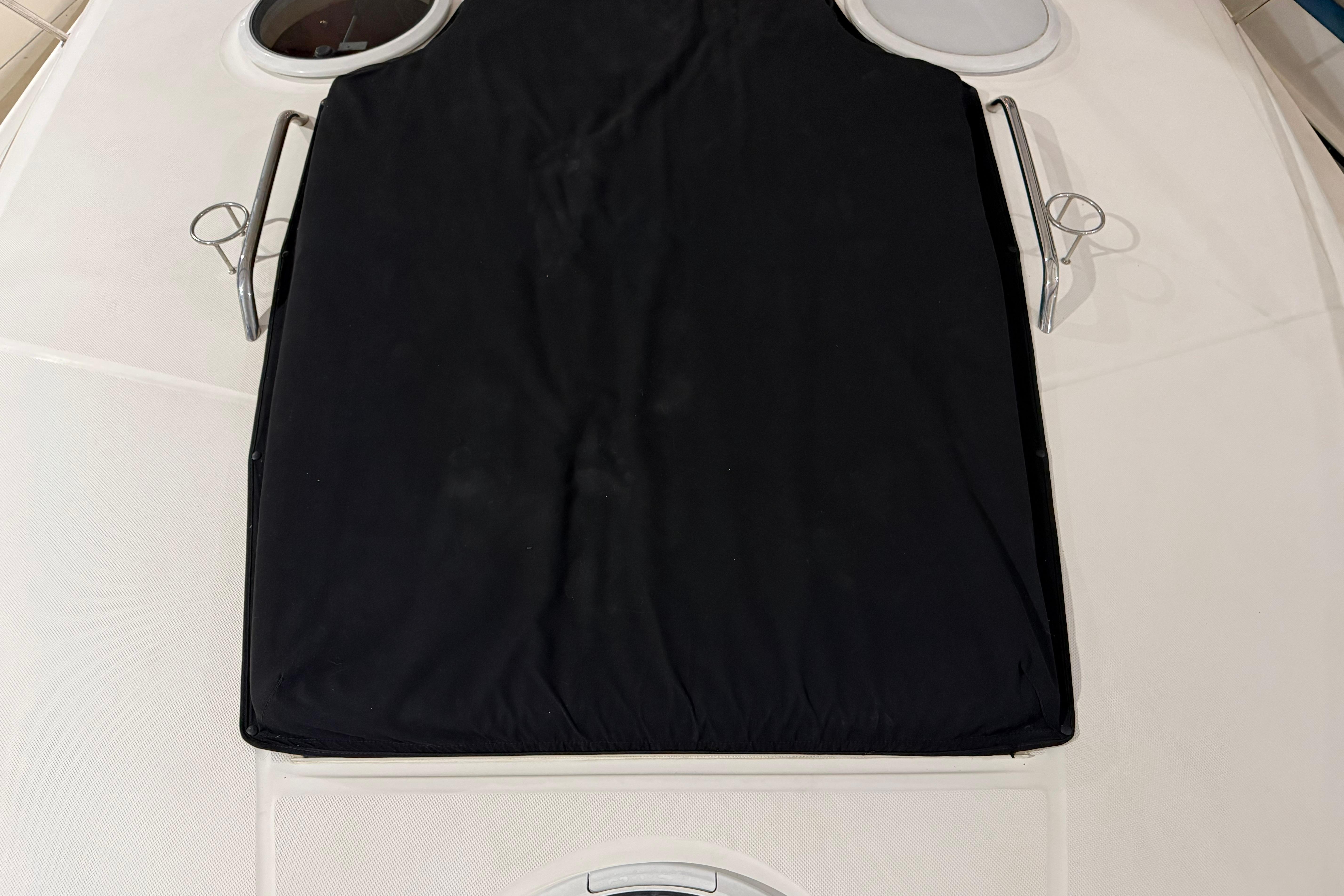 2007 Regal Commodore 3760 IO boat deck with black cover and circular windows.