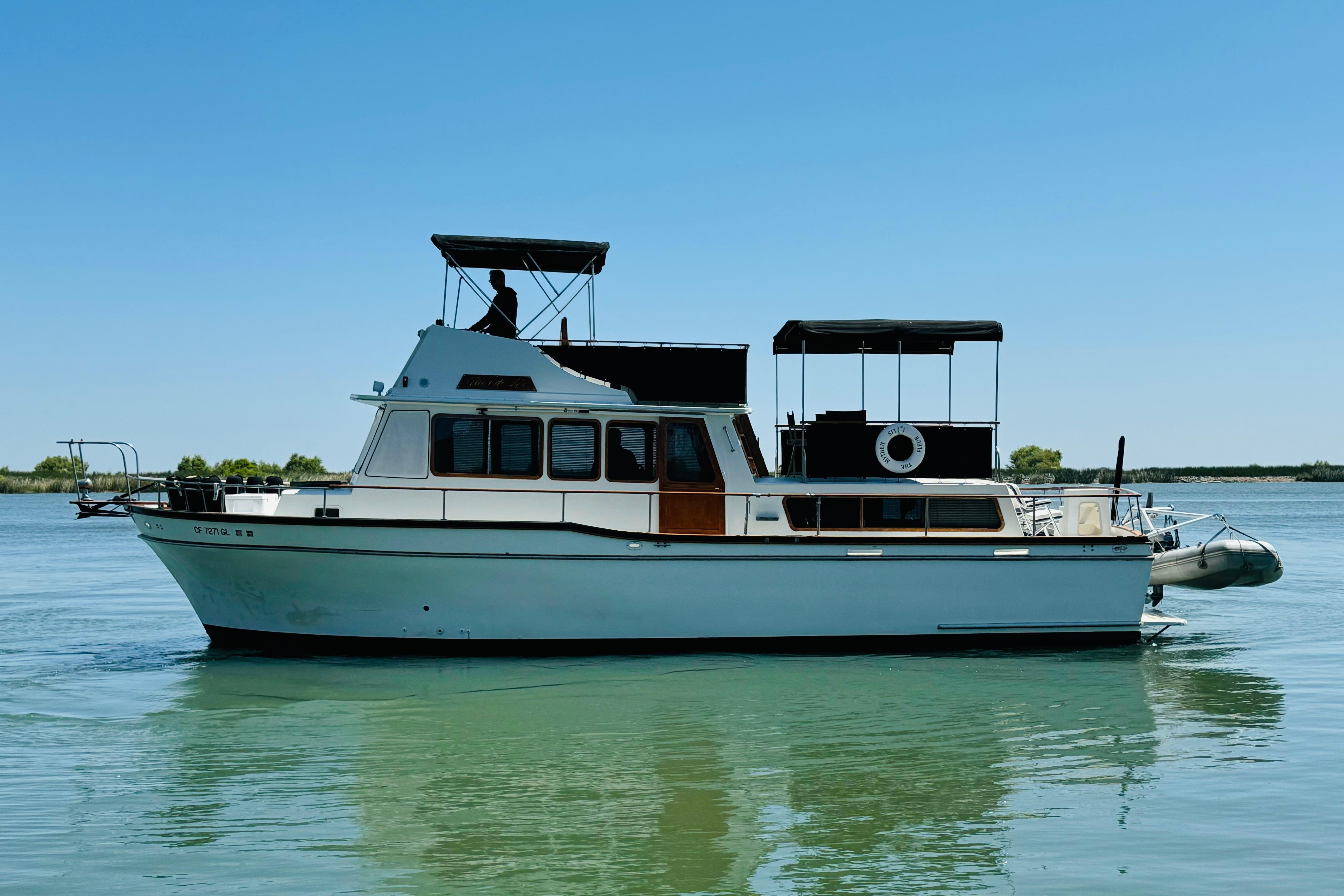 1978 Californian 42 LRC yacht on calm water under clear blue sky.