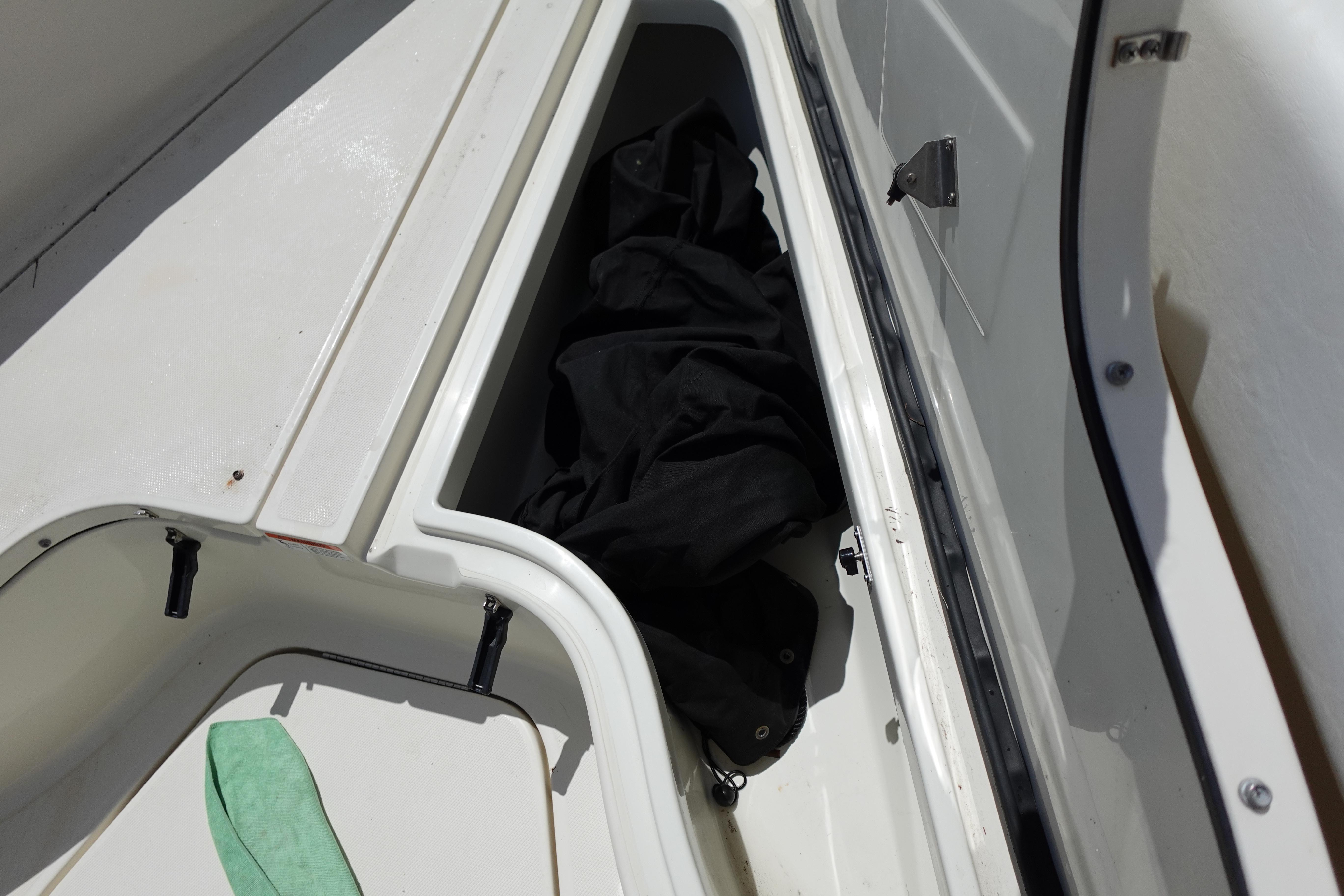 Storage compartment on a 2005 Hydra-Sports Vector 3300 CC boat, containing black fabric.