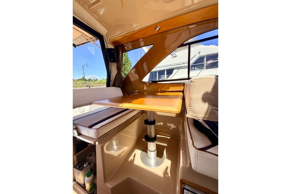 Interior of 2017 Cutwater C-242 Coupe featuring a cozy dining area with wooden table.