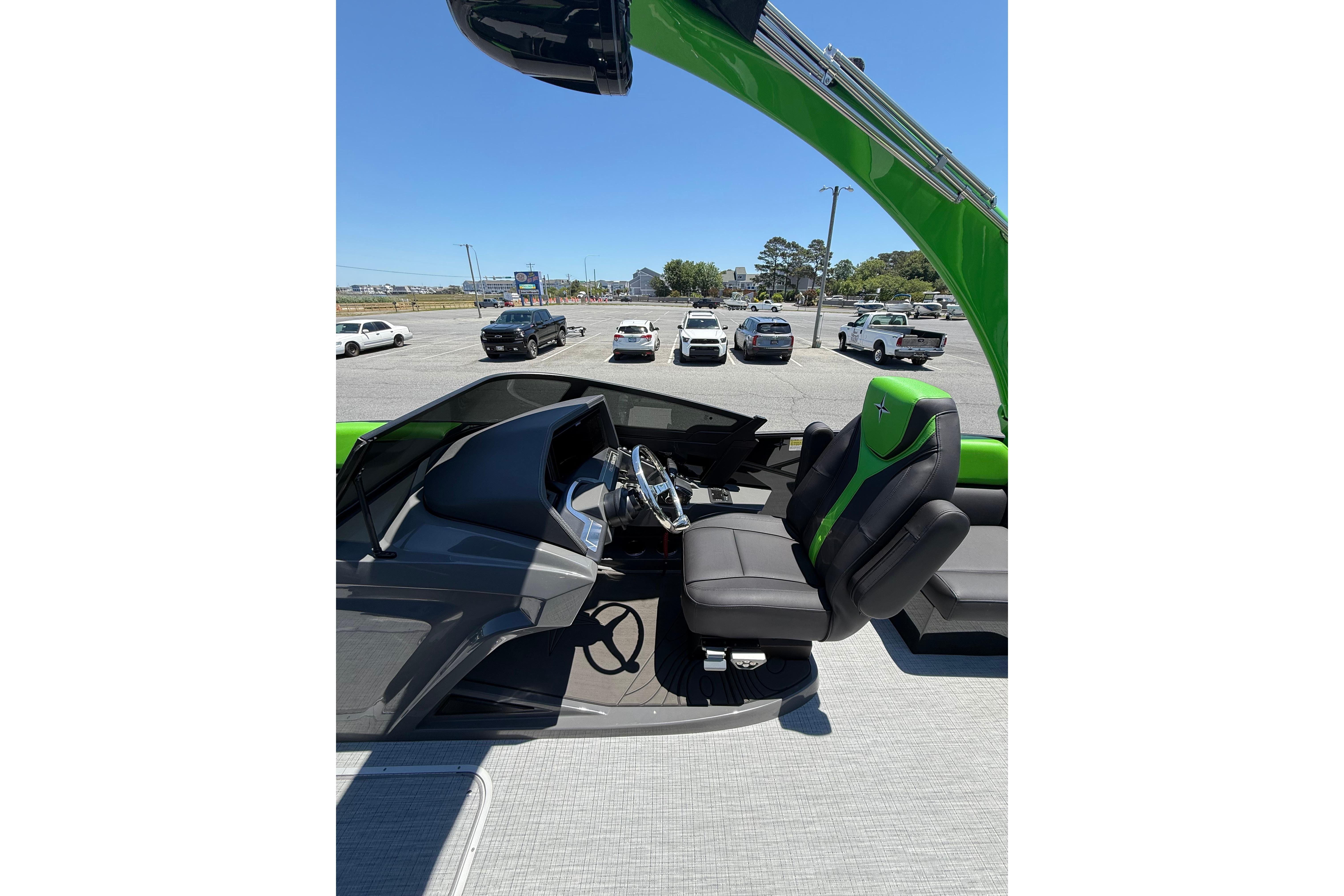 2026 Berkshire Sport SLX9 DC boat interior with green and black seating, parked outdoors.