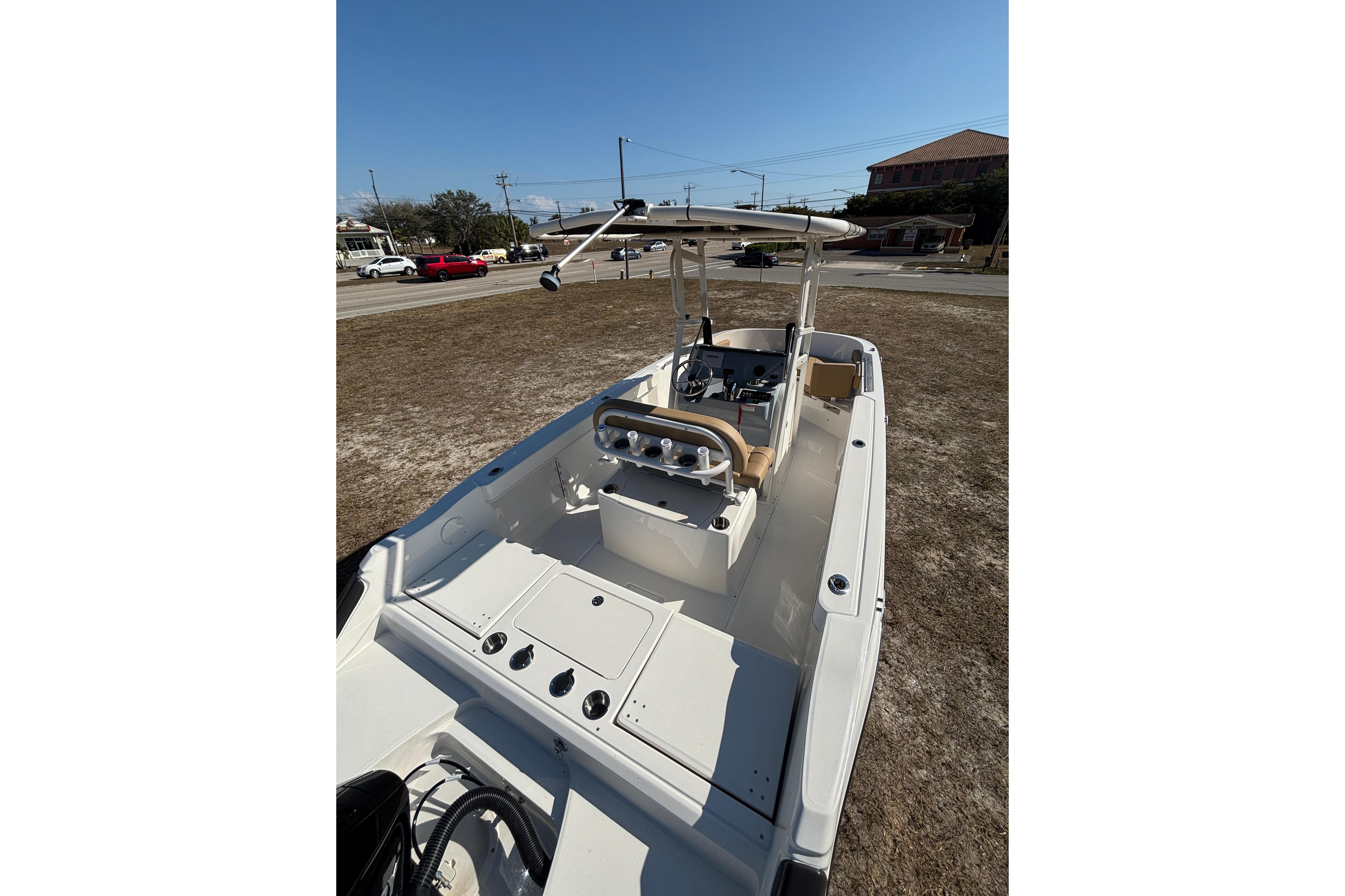 2026 Bayliner Trophy T22CC boat with center console and seating, parked on dry land.