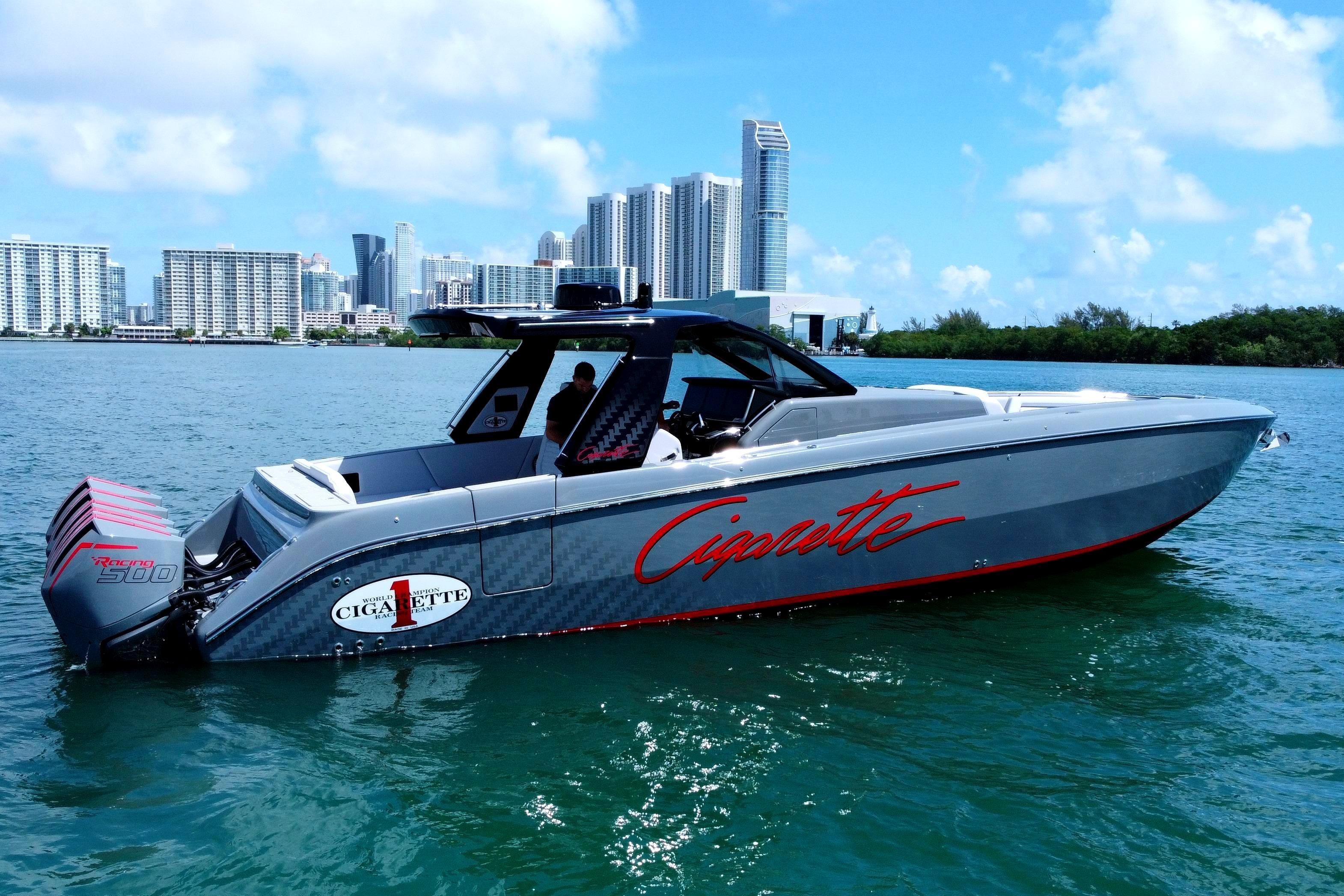 2026 Cigarette 42' Auroris boat cruising near city skyline on a sunny day.