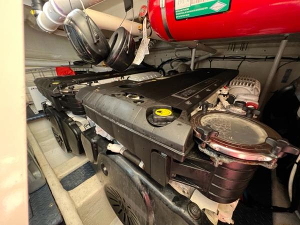 Engine room of a 2009 Ovation 52 yacht with dual engines and fire suppression system.