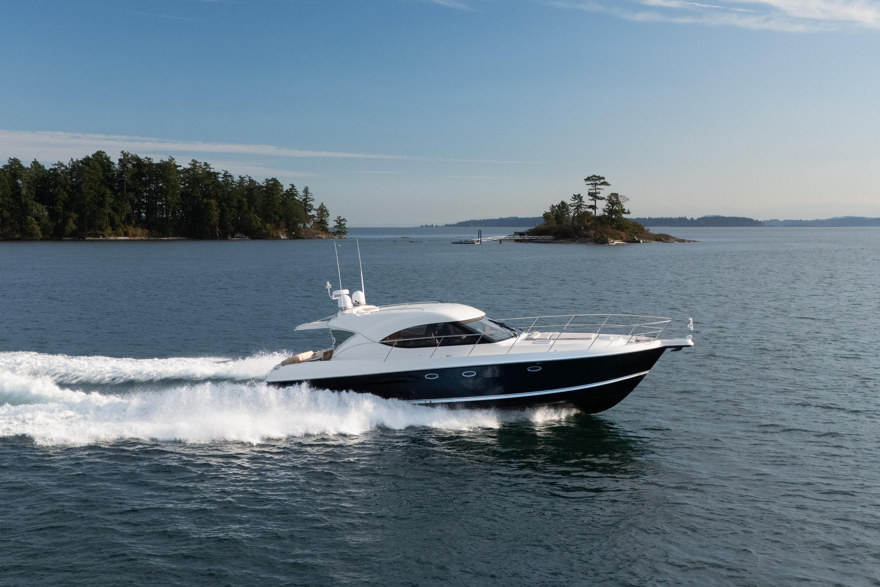 2011 Riviera 5000 Sport Yacht cruising on open water near a small island.
