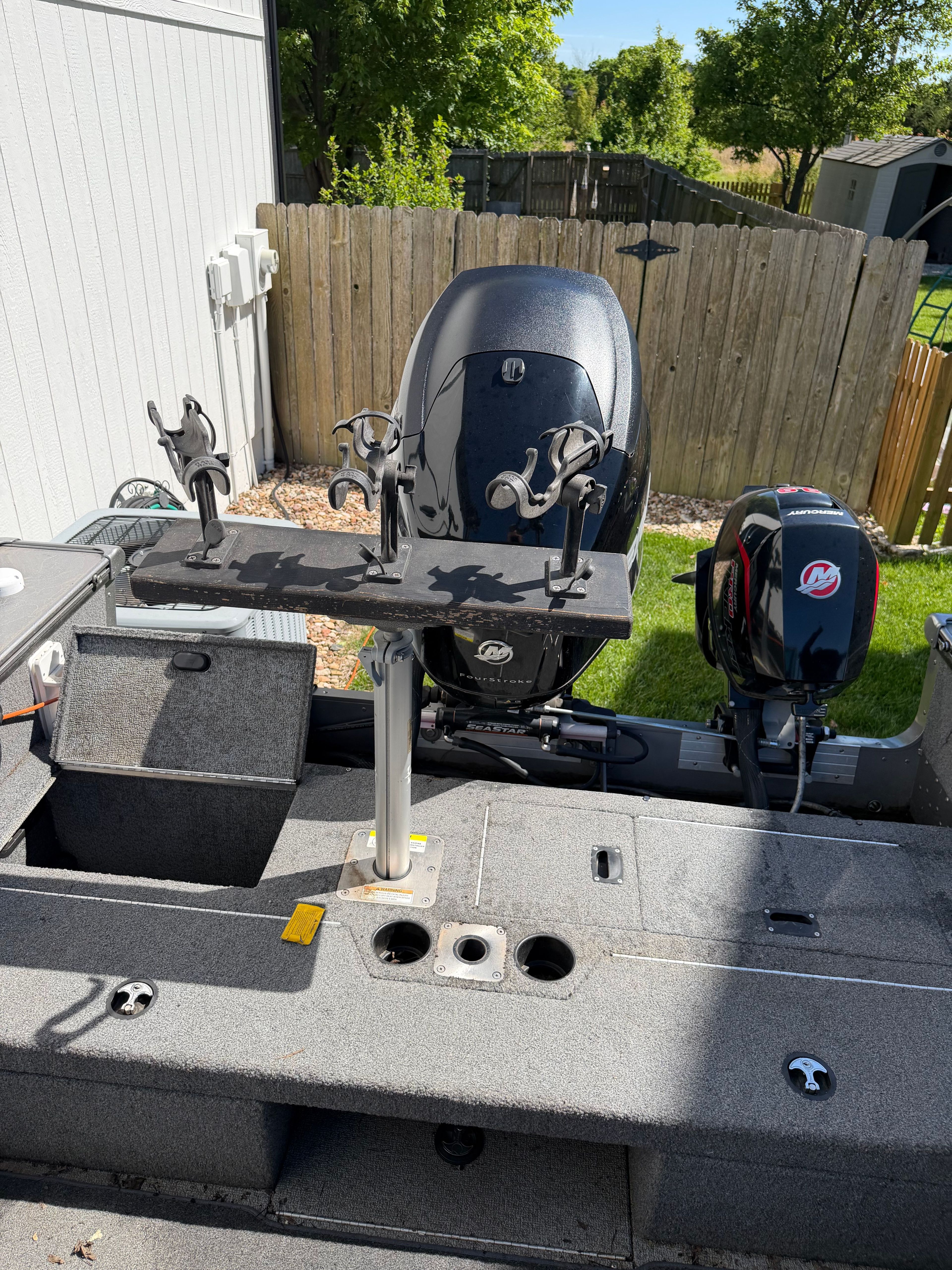 2017 Lund Pro V 1975 boat with outboard motors in backyard.