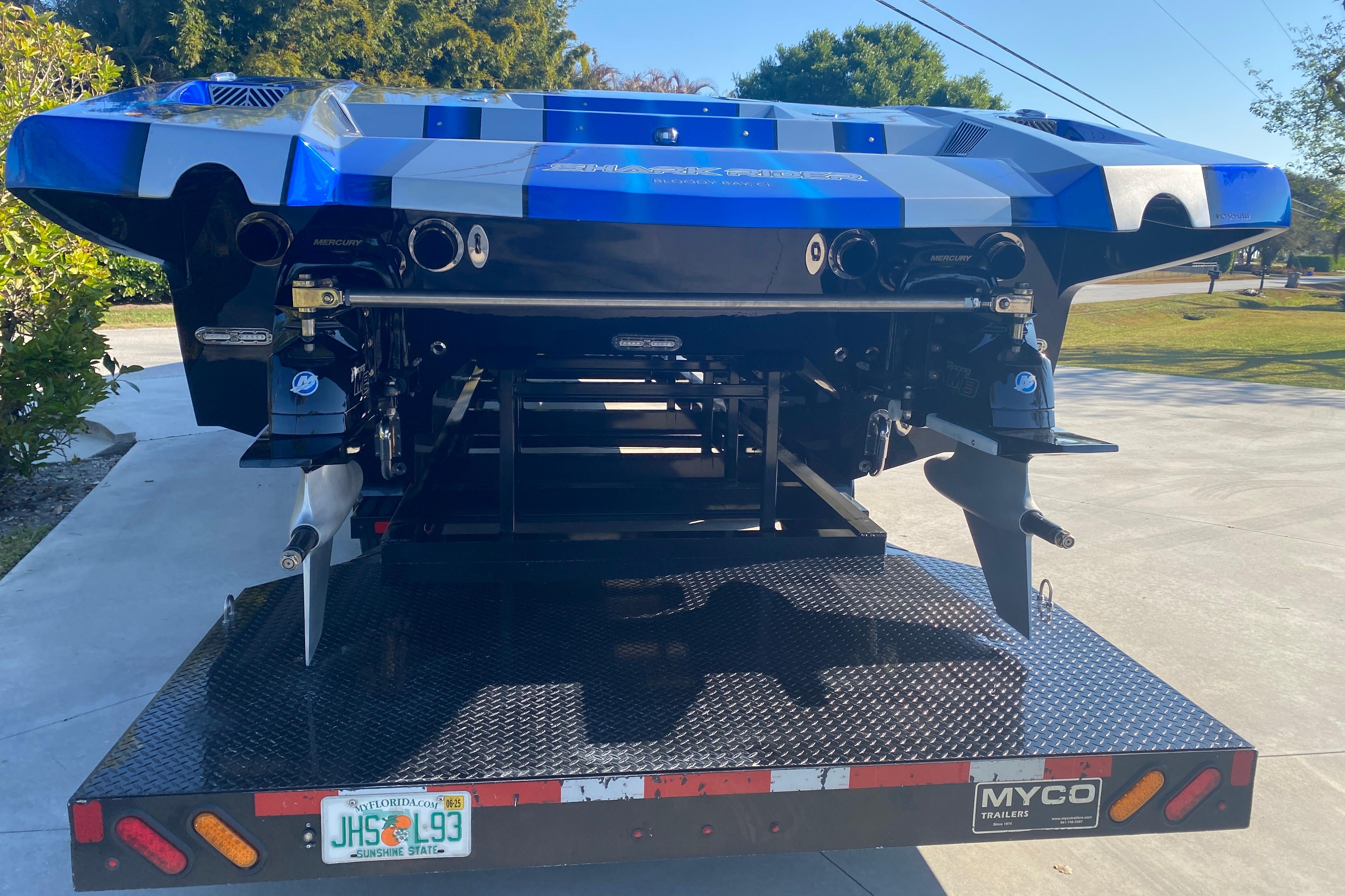 Rear view of a 2016 MTI 44 RP boat on a trailer, showcasing dual propellers.