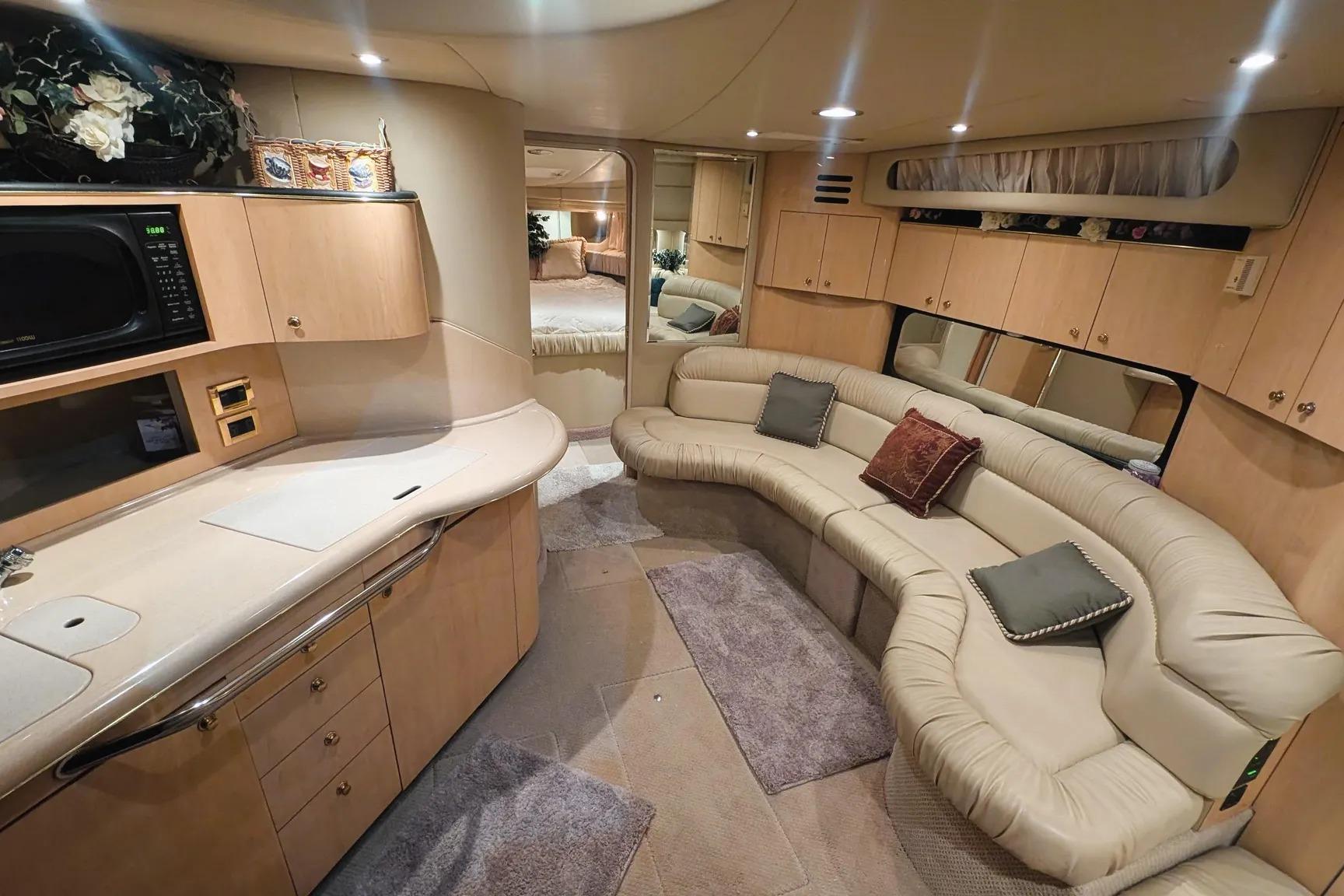 Luxurious interior of 2000 Sea Ray 380 Sundancer yacht with plush seating and modern amenities.
