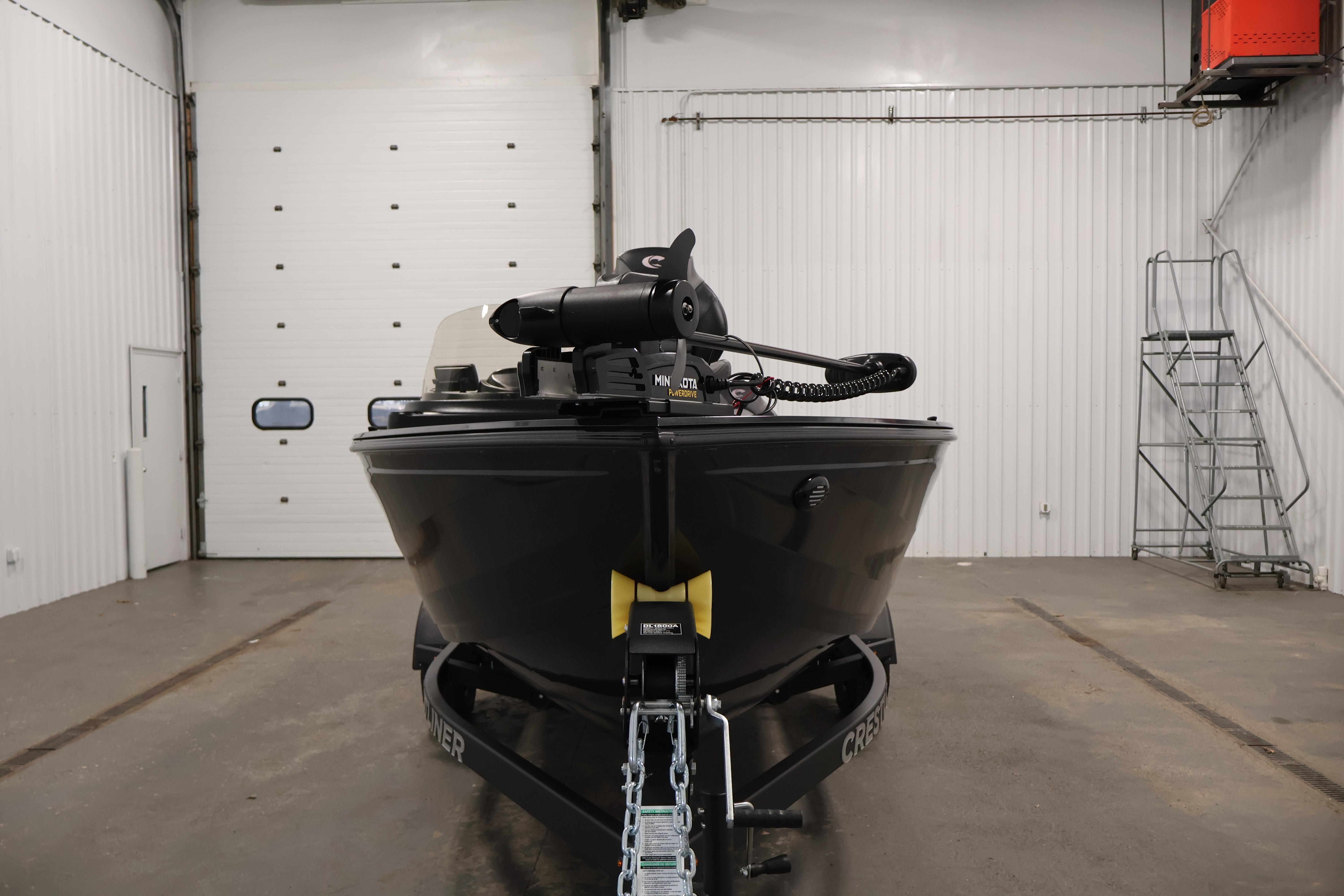 2026 Crestliner 1850 Kodiak SC boat in a garage, front view.