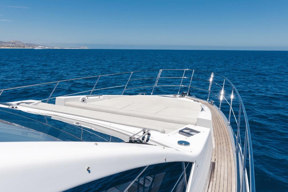 Luxurious 2020 Azimut 60 yacht cruising on open blue sea under clear sky.