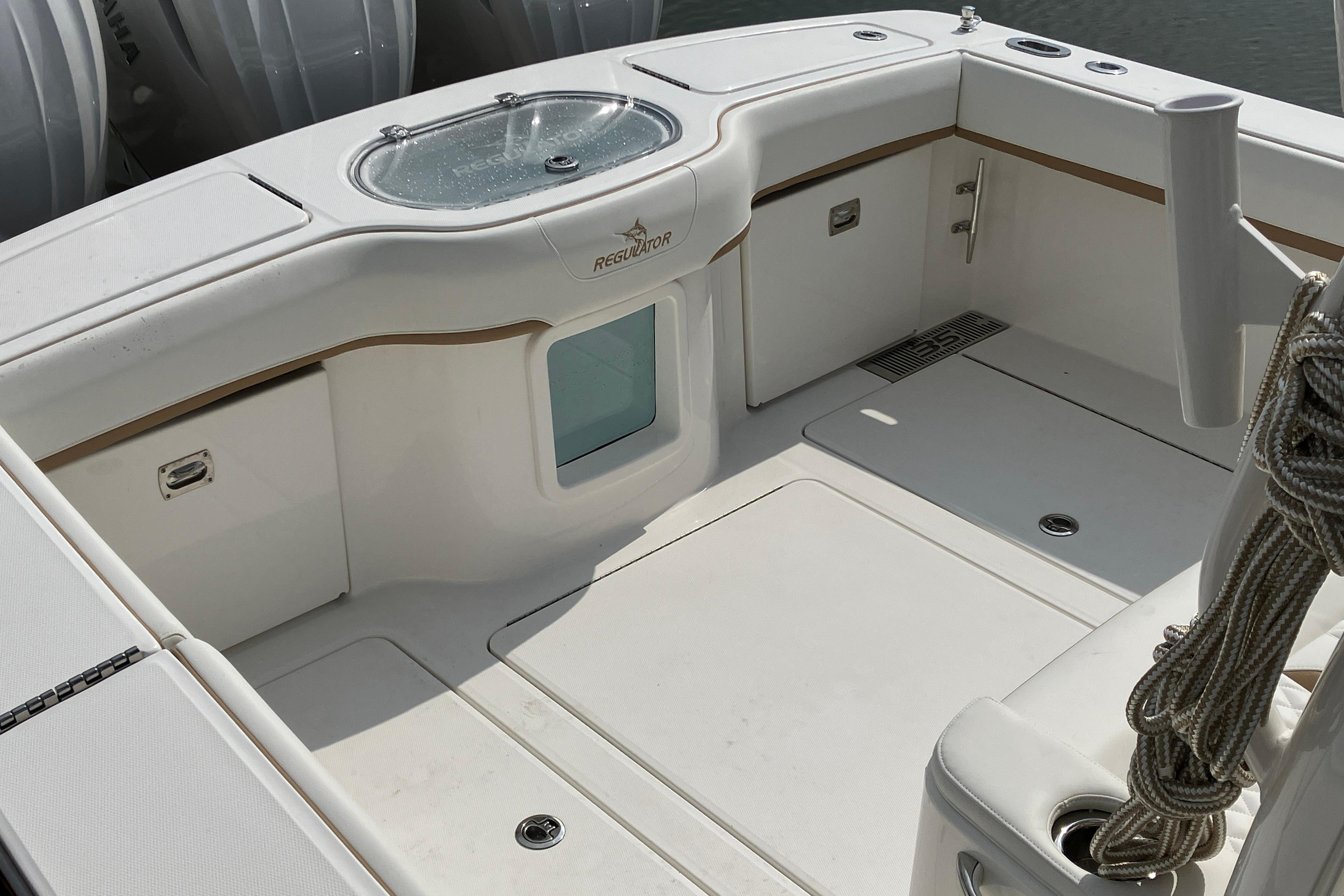 2027 Regulator 35 boat deck with storage compartments and rope, showcasing sleek design.