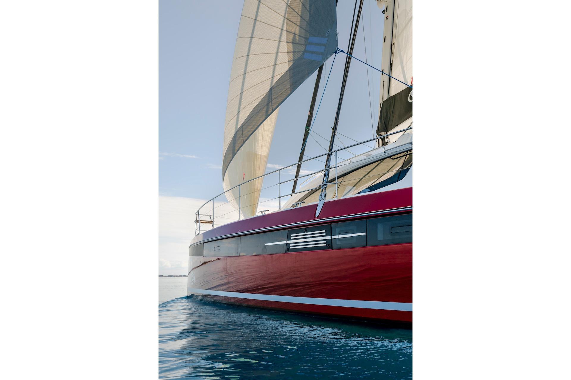Red Privilege Signature 510 sailboat, 2025 model, on calm water.