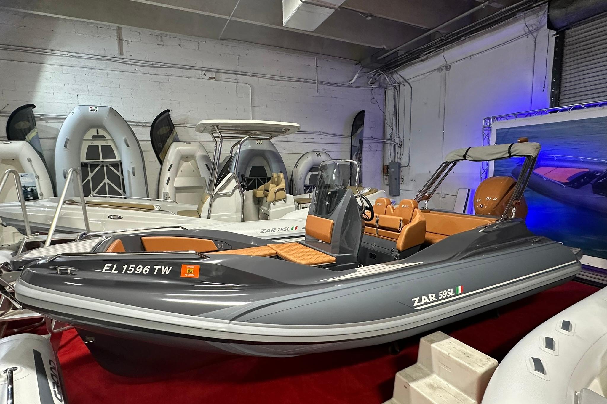 2025 Zar Formenti 59 SL/Limited boat displayed in a showroom with other vessels.