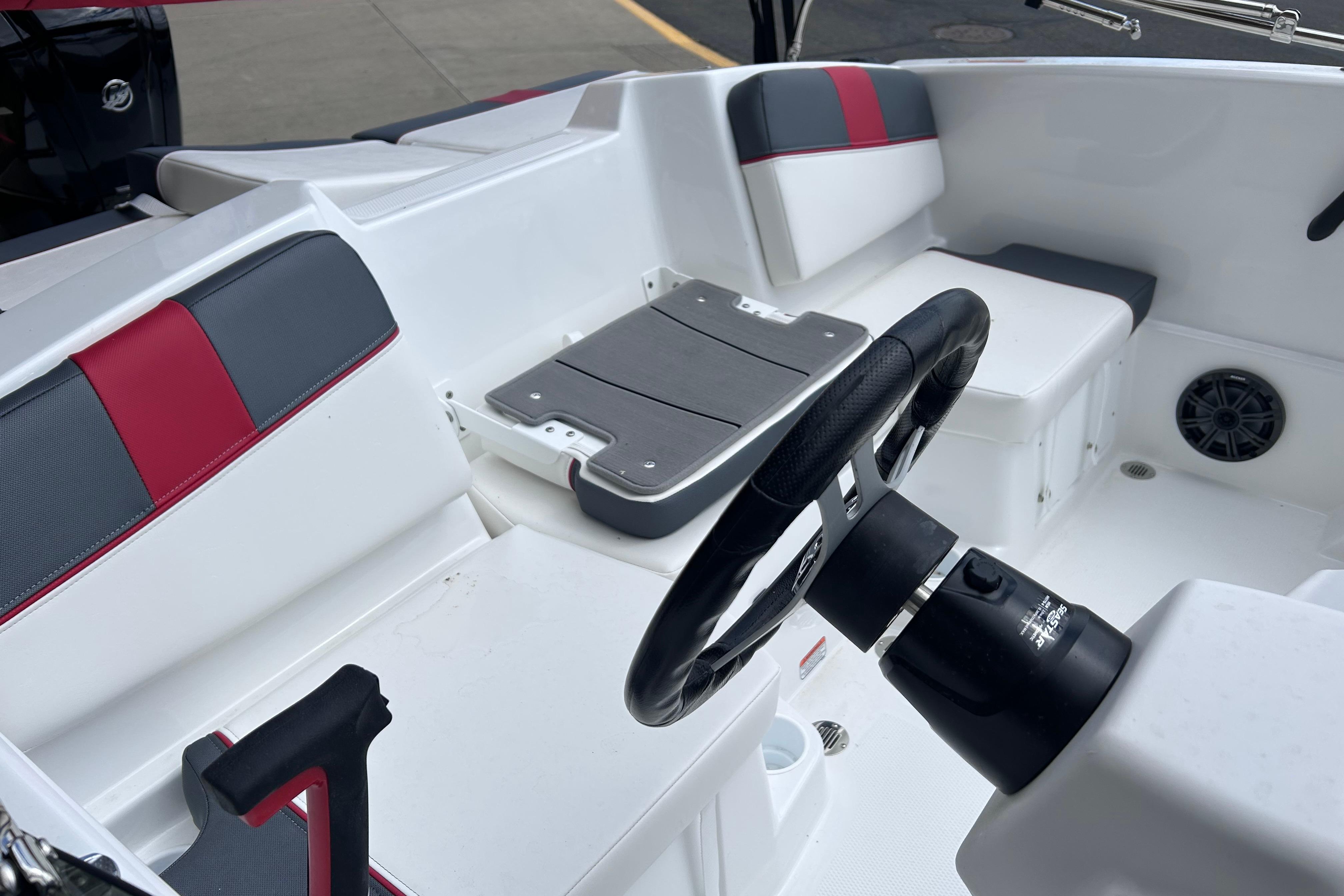 Interior of 2026 Tahoe T16 boat with steering wheel and seating.