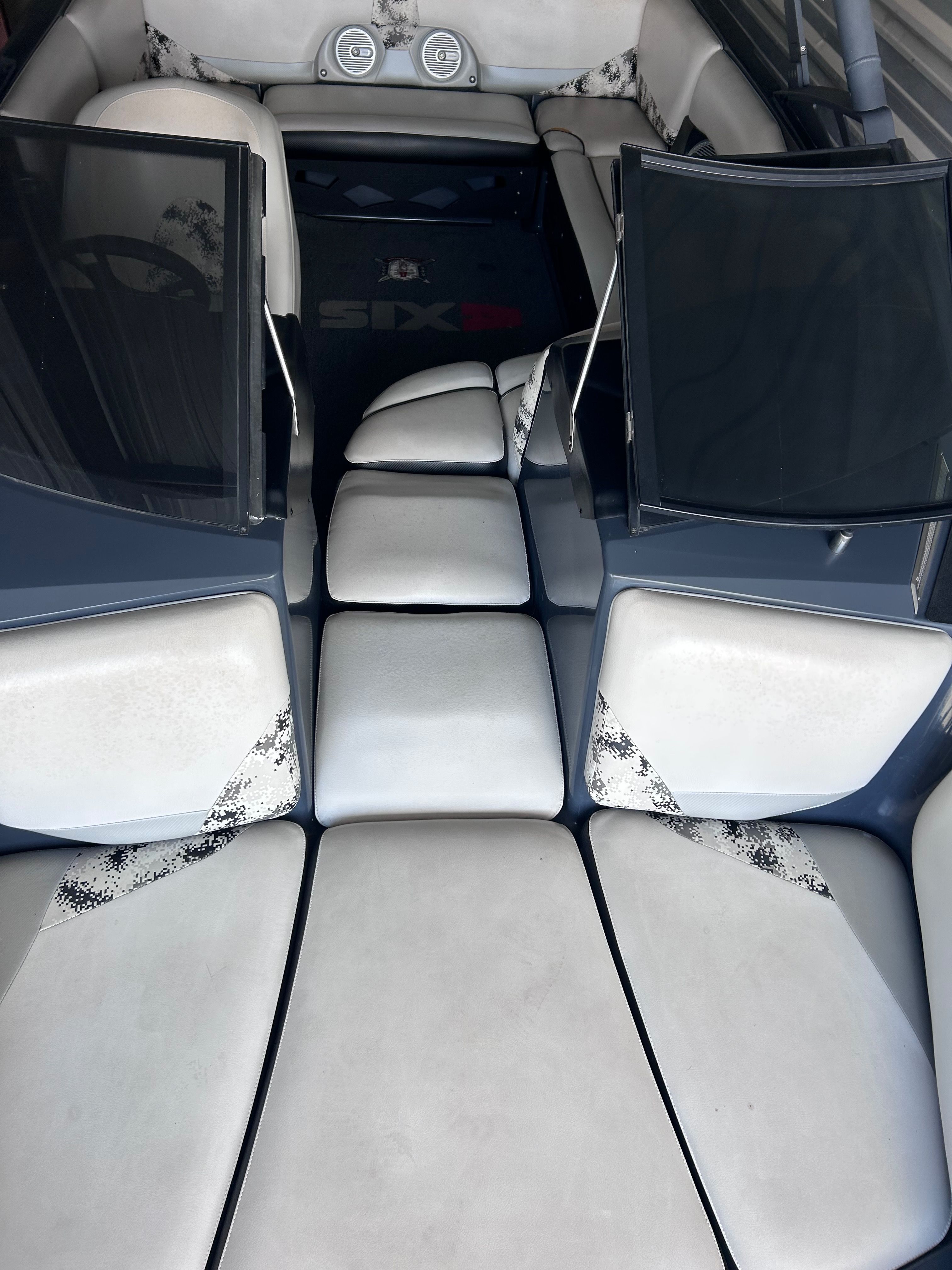 Interior of a 2013 Axis A22 boat with white upholstery.