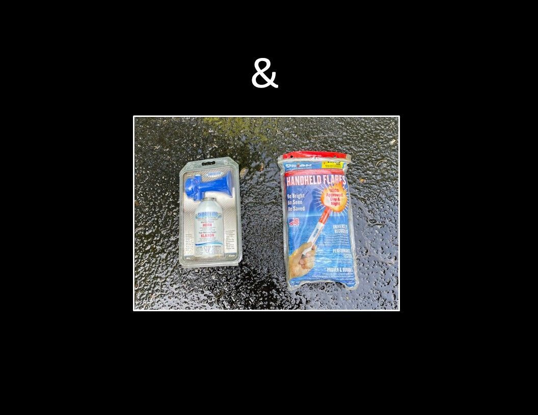 A signal horn and handheld flares on a wet surface.
