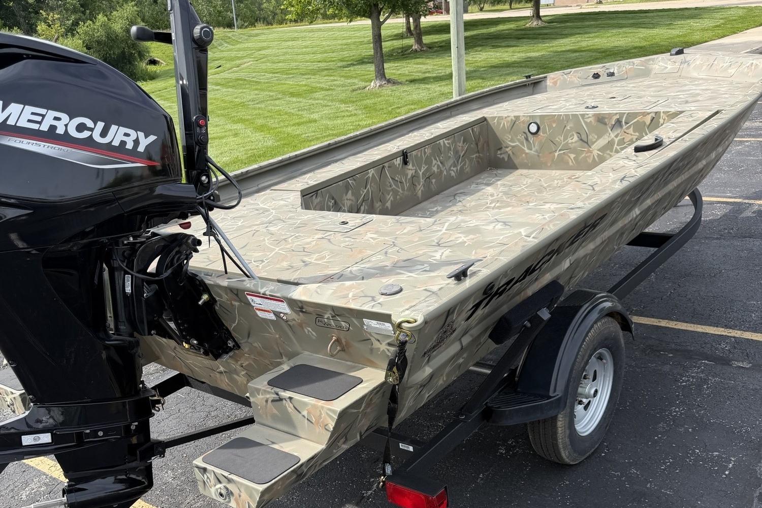2025 Tracker Grizzly 1654 T Sportsman boat with Mercury engine on trailer.