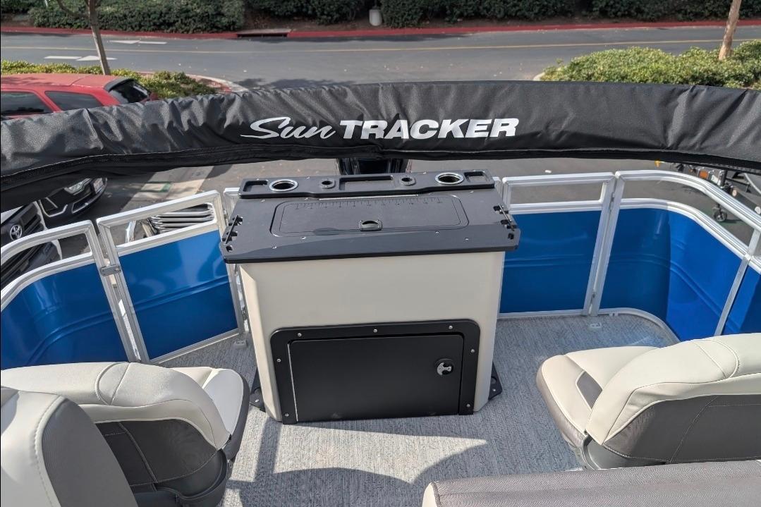 2026 Sun Tracker Fishin' Barge 20 DLX interior with seating and storage.