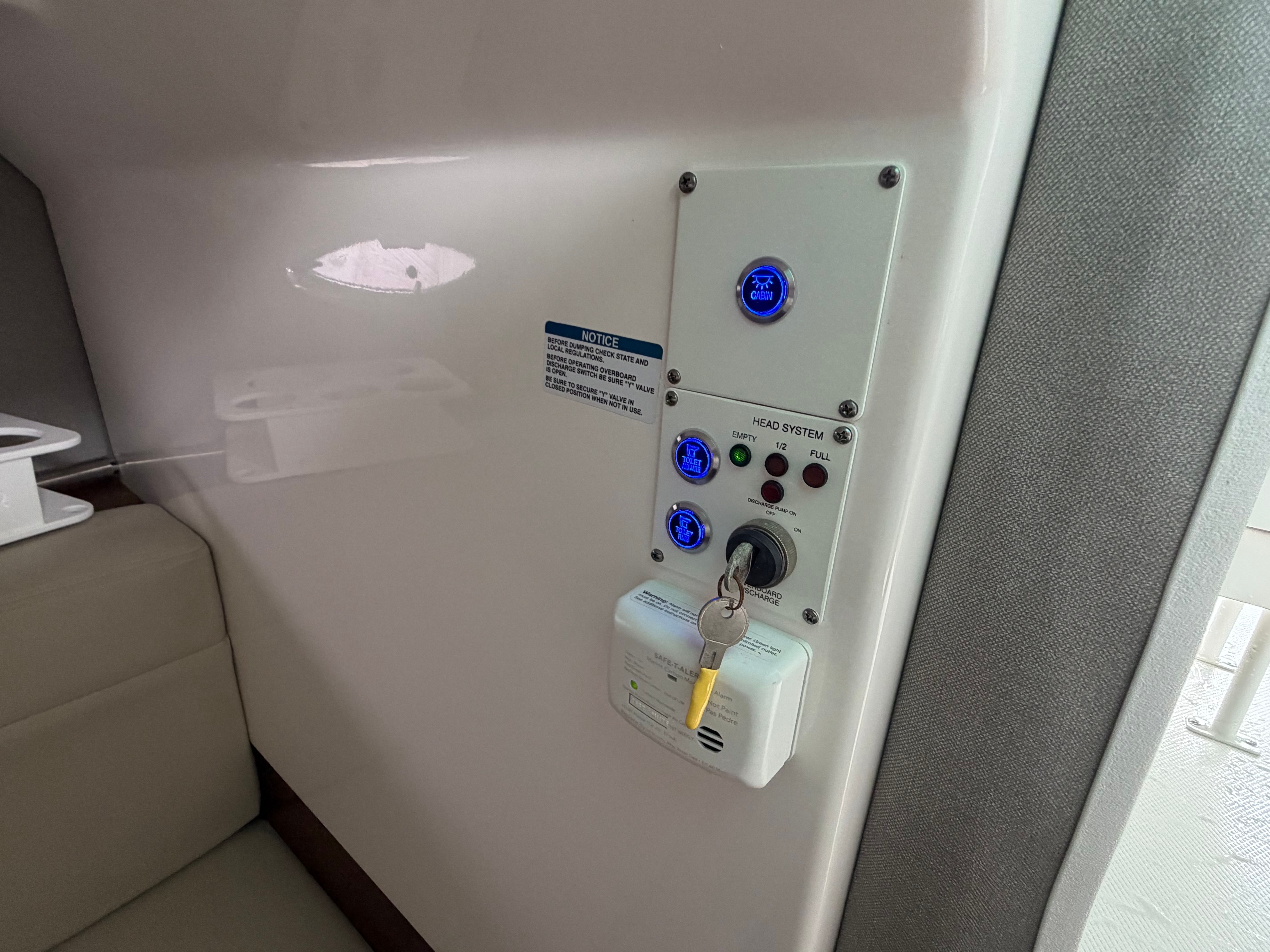 Interior view of a boat with control panel and key switch.